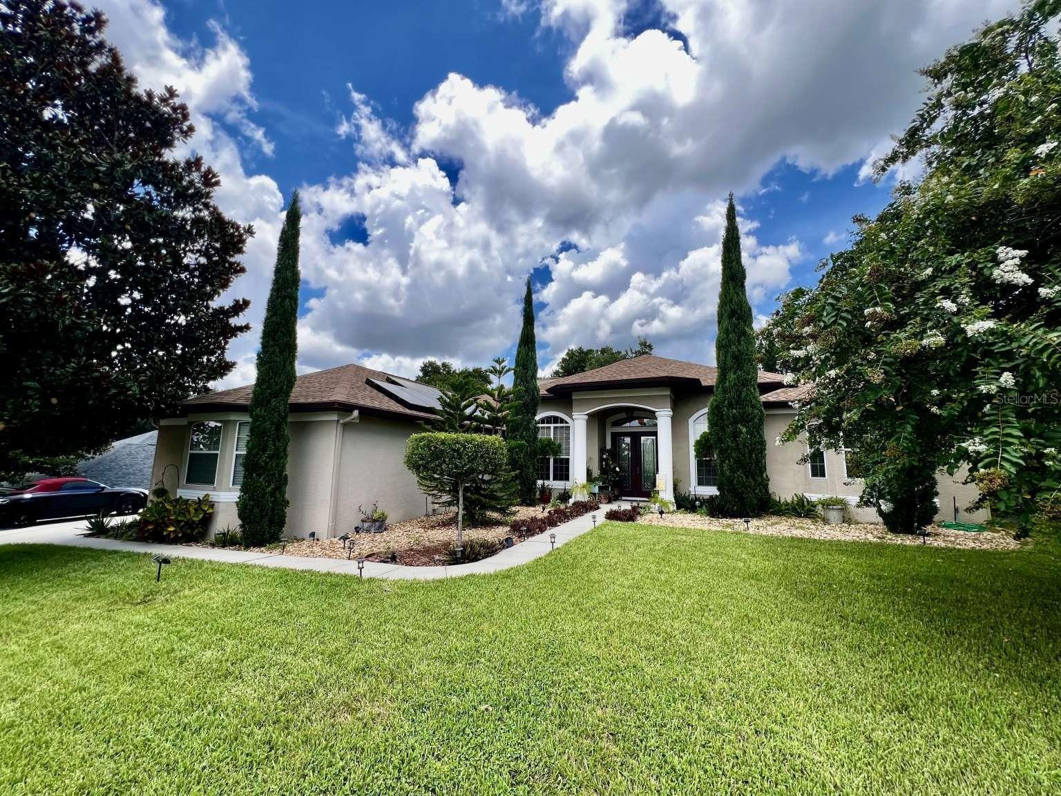 Price improvement!!! MOTIVATED! Welcome to this amazing 4 bedroom, 3 bathroom, 3 car garage home, custom built with breathtaking views from the front and back yards! This wonderful home is loaded with upgrades including vaulted tray ceilings, double front door, crown molding, tile floors, lever hand sets with 8 foot master bedroom and office/ bedroom doors, recessed lighting, knockdown textured walls and ceilings and more. The living room offers huge 10’ stacking sliders that look out onto an extensive, panoramic views of nature in your own backyard. The covered lanai extends the entire back of home and overlooks that beautiful nature and a new, brick paver patio and fire pit. Blessed with mature landscaping around the home. Enjoy your privacy with abundant space between the homes, you won’t feel like you are on top of your neighbors. There is plenty of room to expand up or back, or add a pool! This home features double panned insulated windows and custom light features throughout Enjoy cooking in your gourmet kitchen with stainless-steel appliances and beautiful over-sized cabinetry. The master bed/bath was built for comfort with its fully tiled and glassed walk-in shower, and an elevated over-sized master bathtub. The home features a split floor plan offering complete privacy for the master suite and office. The family room, kitchen and dining room are all on one side and single level make this home great for everyone . The 4th bedroom could be used as a home office. BONUS: This home is fully solar and solar is completely paid for!!! No maintenance 25 year warranty. Our ELECTRIC BILL is usually UNDER $40!!! Before Installing Solar our electric bill was $500+… and rising. New roof in 2022!! Home Warranty is transferable, covers HVAC and appliances so no worries! This gem will not last and is ready for you and your future!!