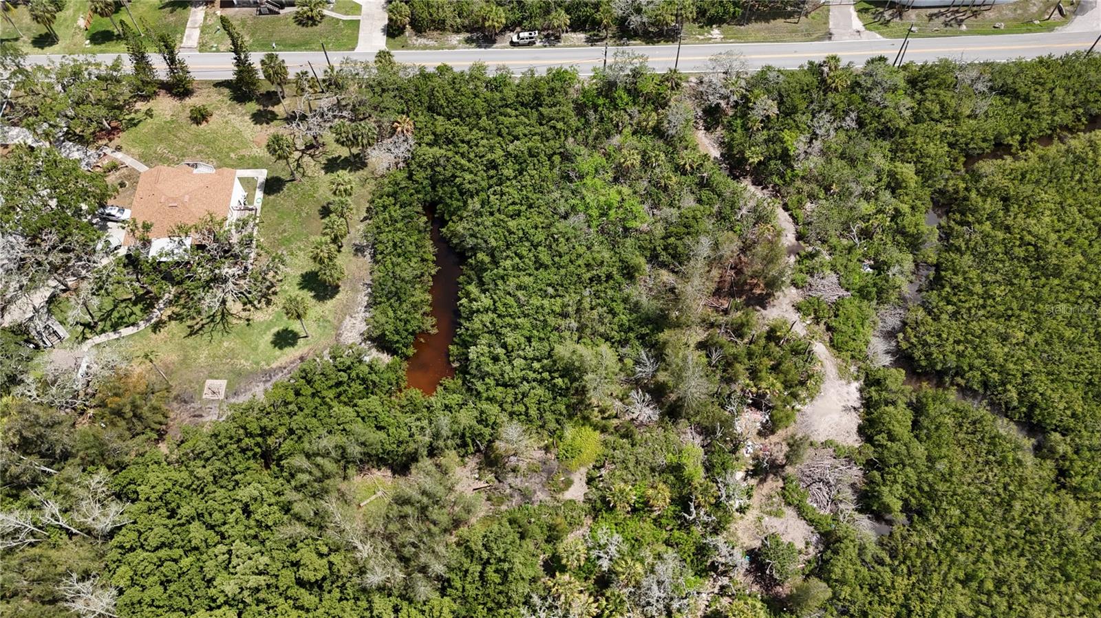 Discover your own slice of Florida's Nature Coast on this beautiful 2.5-acre homesite in the New Port Richey area. Offering the perfect balance of privacy and convenience, this property is just minutes from the Gulf of Mexico, where you can smell the salt in the air, feel the afternoon sea breeze, and enjoy the laid-back coastal lifestyle that makes this part of Florida so special.

Whether you're planning to build your forever home, a seasonal retreat, or simply invest in land, this property provides the space to make it your own. Towering native trees and natural Florida surroundings create a peaceful setting while still keeping you close to shopping, dining, and everyday conveniences.

Outdoor enthusiasts will appreciate the easy access to boating, fishing, kayaking, and waterfront parks. Launch your boat from Anclote River Park Boat Ramp, spend the day exploring Anclote Key Preserve State Park, or enjoy spectacular Gulf sunsets from Robert K. Rees Memorial Park. For those who enjoy hiking, biking, and wildlife, Jay B. Starkey Wilderness Park is just a short drive away.

Imagine mornings with coffee on your future porch as the sea breeze drifts through the trees, afternoons spent on the water, and evenings under brilliant Gulf Coast sunsets. Large parcels this close to the Gulf are becoming increasingly difficult to find—don't miss your opportunity to own a piece of Florida's coveted Nature Coast.