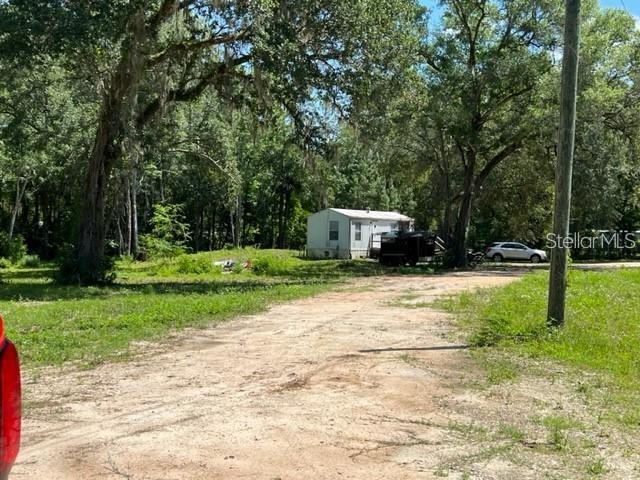Motivated seller! This exceptional 4.11-acre property, zoned A-1. offers a rare opportunity to enjoy true privacy and wide-open space. The property features a manufactured home with 1 bedroom and 1 bathroom, ideal for comfortable living while planning future improvements. A long private drive leads from the main road, creating a peaceful and secluded atmosphere. One of the highlights is the expansive 50x25 workshop with a roll-up overhead door, along with a 15x13 attached office—perfect for business operations, storage, or creative projects. With no deed restrictions, the possibilities are endless, whether you envision a private retreat, hobby farm, or custom compound. The property is equipped with electricity, a private well, and septic system. Conveniently located near WEC, HITS, shopping, hospitals, and everyday amenities, offering the perfect balance of rural living and accessibility.