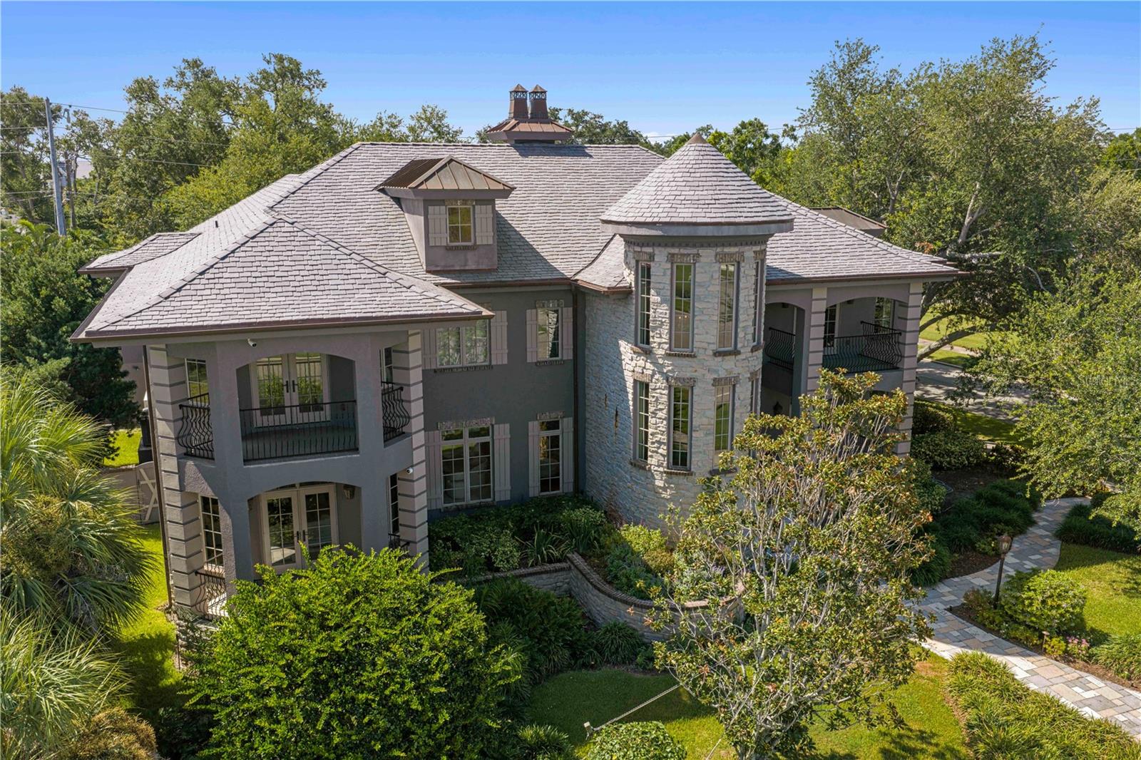 Affectionately known as "The Castle," this exceptional 4BR/4.5BA, 5,640 SF Snell Isle estate was designed by renowned architect Daniel Dawson and built with cinder block construction on both levels. Situated on an oversized lot just moments from the Vinoy Golf Club and downtown St. Petersburg, the home features custom Allikriste cabinetry, walnut floors, a Wolf range, oversized island, beverage drawers, indoor/outdoor wood-burning fireplaces, beach-entry pool, steam shower, Generac generator, and award-winning landscaping. A grand turret staircase and spiral mudroom staircase complement the home's timeless architecture and exceptional craftsmanship.