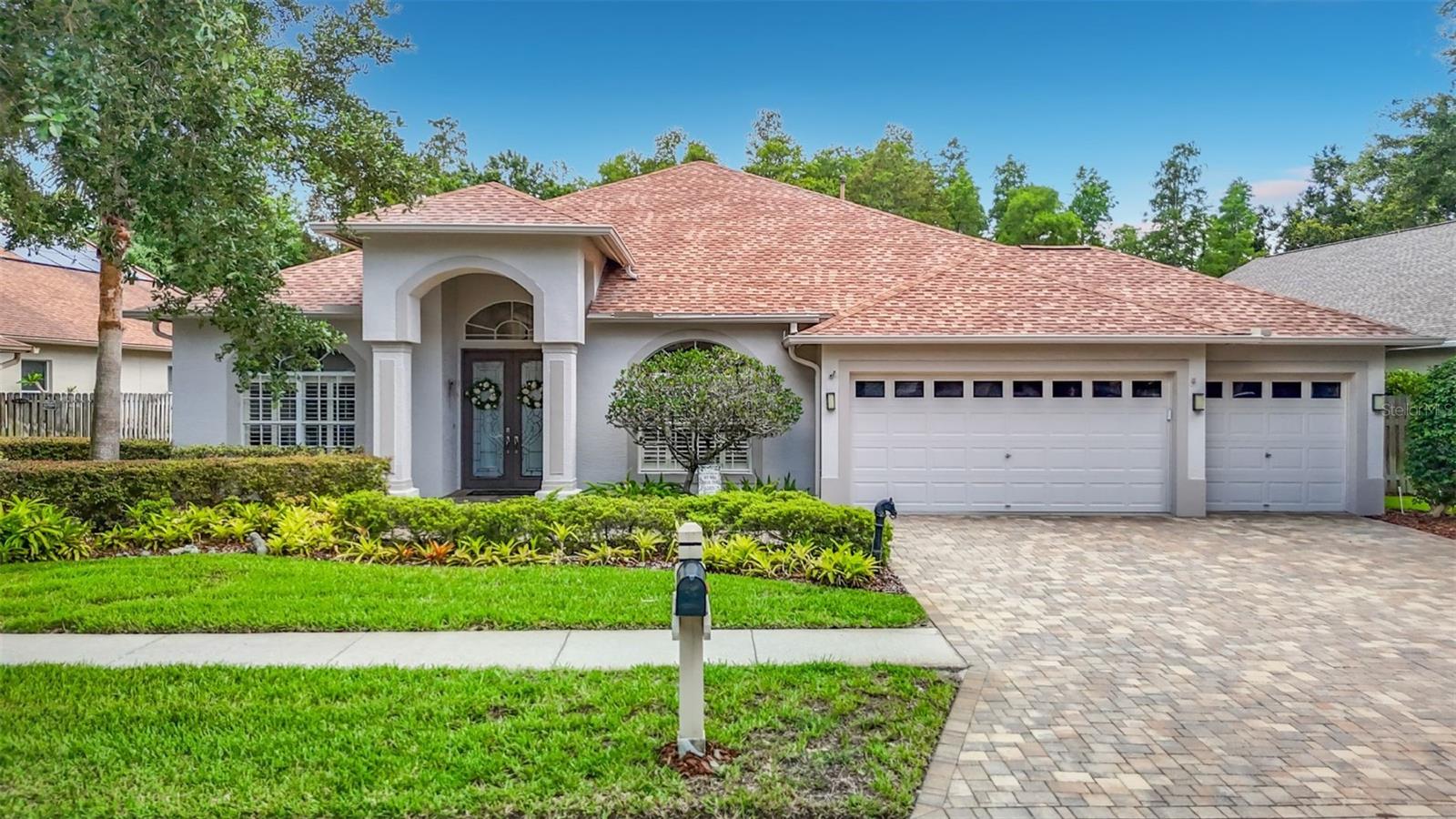Welcome to magnificent family living in the highly sought-after Villa Rosa community of Lutz. Perfectly positioned on a serene conservation homesite, this beautifully maintained 4-bedroom, 3-bath, 3-car garage residence offers approximately 2,927 square feet of thoughtfully designed living space that blends elegance, comfort, and exceptional outdoor entertaining. From the moment you arrive, the striking concrete paver driveway and manicured landscaping create an inviting first impression. Inside, spacious living areas and a well-designed floor plan provide the ideal balance of open gathering spaces and private retreats, making the home equally suited for everyday family life and entertaining. One of the home’s most captivating features is the beautiful conservation area, which serves as the backdrop for the entire rear of the property, providing peaceful, private views from the main living area, the kitchen, the dining room, master's suite and bedroom four. With no rear neighbors, the natural setting creates a sense of tranquility that is increasingly difficult to find. The true centerpiece of the property is the expansive screened lanai overlooking this stunning conservation preserve, creating a private outdoor oasis. Enjoy Florida living year-round with the sparkling pool and a fully equipped outdoor kitchen featuring a gas oven, refrigerator, sink, and granite countertops—perfect for hosting family celebrations or relaxing evenings with friends while taking in the lush natural surroundings. Adding to the home’s versatility, the oversized fourth bedroom offers a unique private suite feel with its own attached bathroom and direct access to the pool and lanai. This flexible space is ideal for guests, multi-generational living, a workout room, or a teenager’s retreat, providing both extra privacy and additional functional living area. Completing the home's functionality is its separate private study with glass French doors creating a perfect work-from-home office, game room, or multi-use space. Located within the desirable Augusta Ridge gated section of Villa Rosa and zoned for highly regarded McKitrick Elementary, Martinez Middle, and Steinbrenner High Schools, this home offers access to some of the area's top schools while remaining convenient to premier shopping, dining, parks, and major commuter routes. With its premium conservation lot, breathtaking nature views throughout the home, exceptional outdoor living spaces, flexible floor plan, and location in one of Lutz’s most coveted family neighborhoods, this is a rare opportunity to enjoy the very best of Florida living.
