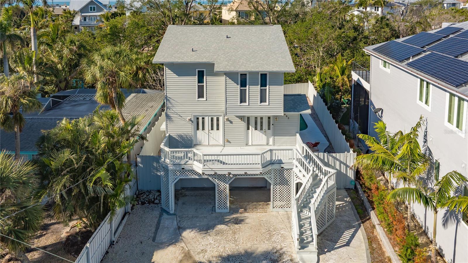 Beaches, Boating & Bistros. This 3 bedroom, 3 bathroom home has it all. Beaches: Located on Palm Island, an Island on an Island only a 2-minute walk to the world-famous cool quartz sands of Siesta Beach (Beach Access #10). You can walk for miles along the sparkling Gulf waters and watch the dolphins play. Kick back on the white sand, go swimming in the clear water, or simply admire the sunset — it's up to you.  Boating: Dock your boat at your back door and take a dip in your pool after spending your day on the water. Your private dock is equipped with a beamless 14,000 boatlift on the Grand Canal. Just a short boat ride to world class fishing and watersports. Bistros: You are less than a mile from Siesta Village, yet Palm Island is a secluded oasis accessed by a bridge. Siesta Village boasts a variety of world class restaurants and nightlife. The property is fully fenced with no homes on the other side of the canal. This private elevated Key West style home offers a great investment or a home for your family. Open floor plan with kitchen/dining/great room layout. Vaulted ceilings create a wonderful open feeling with sliders bringing in the outdoors. Lots of space for storage on the lower parking/storage area.  Newer roof and HVAC.