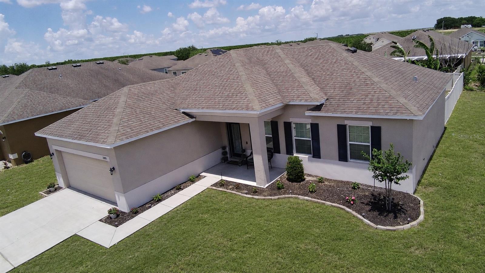 Welcome to this gorgeous 2016 Maronda Homes Fairfield model located in the desirable Mabel Loop Ridge community of Dundee! HOA only $35.42/month. Situated on a corner lot with a covered front porch that provides relaxing shade and charming curb appeal, this move-in-ready home offers beautiful upgrades, flexible living space, and a thoughtfully designed open floor plan. The Fairfield model is known for its functional layout, spacious living areas, and desirable split-bedroom design perfect for everyday living and entertaining.

Step inside to tall ceilings, crown molding, large ceramic tile throughout the main living areas, and a bright open-concept layout that feels both spacious and inviting. The showstopping gourmet kitchen features granite countertops, a pantry, and all appliances included, making it ideal for cooking, hosting, and gathering with family and friends.

The spacious primary suite is a true retreat featuring a beautiful ensuite bath with dual granite vanity sinks, an extra-large tiled walk-in shower, and a generous walk-in closet. Two additional bedrooms offer great space and comfort, while the flex room with elegant glass doors provides the perfect office, den, playroom, or guest space. The designated indoor laundry room includes the washer and dryer for added convenience.

Enjoy Florida living year-round on the extra-large covered and screened lanai overlooking the vinyl-fenced backyard. The owner also installed a large storage shed for extra storage space. The 2-car garage currently features attractive wood plank flooring and can easily continue to function as a garage or potentially be transformed into additional living or Florida room-style space. Furniture may also be negotiable, making this home an even easier move for the next owner.

Located near beautiful Lake Marie Park, Dundee offers peaceful small-town charm while still being conveniently close to everything Central Florida has to offer. Residents enjoy easy access to Winter Haven, Lake Wales, LEGOLAND Florida, Bok Tower Gardens, shopping, dining, and major highways leading to Orlando, Tampa, and Florida’s world-famous attractions and beaches. This beautiful Maronda Fairfield model combines comfort, style, flexibility, and location all in one exceptional home.