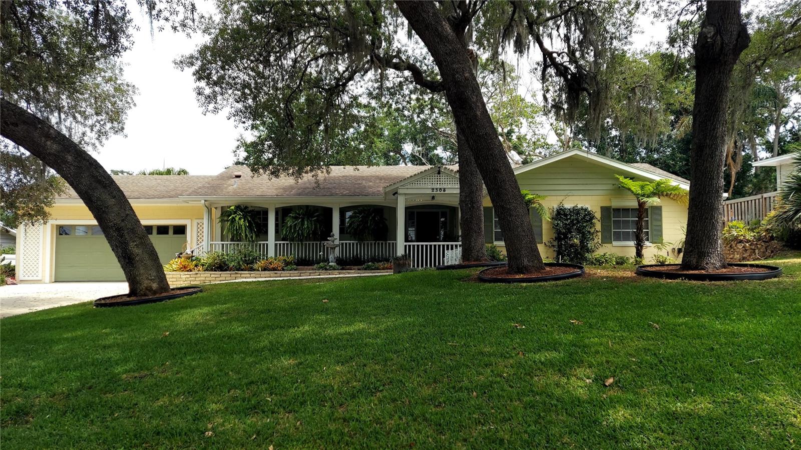 NEW ROOF scheduled for June 15 & 16, 2026. Located on Overlook Dr., sought-after old Mt Dora neighborhood, w/Mature Oak Trees. Stunning Remodeled Home, "Street to Street"-between Overlook Dr & Hillside Dr, with partial water views of Lake Gertrude & Lake John, approx.1.5 miles from Historic Downtown. Residence is on 1 level w/large front & backyards, w/plenty of room for large pool on a flat terrain. 3 Bedrooms, 3 Bathrooms, 2 Car Garage.  Den with Full Bathroom can easily be converted to a 4th Bedroom En Suite. Completely Updated Kitchen w/custom white cabinetry, soft close doors & drawers, lighted drawers, glass display upper cabinets, stainless appliances & 9.5' center island w/seating for 4 barstools. Upper & Lower cabinets with LED lighting. Quartz countertops w/decorative marble backsplash, Cooktop w/Pot Filler. Undercounter wine/beverage cooler. Newer bathrooms w/wall mounted vanities & under cabinet lighting (see photos). The over-sized, meticulously maintained 2 car garage includes separate 240 volt Elec Vehicle charger & add'l refrigerator & work area. There are 4 solar tubular skylights w/night lighting. Tankless water heater. Other features include zoned Sprinkler System, Driveway Parking for at least 6-8 cars. Water/pond feature near entrance w/bird bath & 3 mature fern hanging baskets. There are numerous designer LED ceiling 3" can lights as well as wall lighting for artwork. In addition there is closet lighting & 8 ceiling fans. There is a beautifully covered/enclosed hottub (6-8 people) area off the Primary Bdrm, 22' x 11.5', for private lounging/tv enjoyment. It also features an outside shower. Adjacent to the Breakfast Room is a covered outside porch, approx. 12' x 12', leading to the fenced-in backyard. A Floor Plan with existing furniture is supplied in the photo section. Privacy from the street & neighbors can be appreciated in all directions in this tranquil setting. The home is an entertainer's delight, with great flow and no interior steps. Upon entering the Foyer, you will enjoy an expansive panoramic view of the backyard through the large picture window of the living room & dining room areas. This residence exudes the charm of Old Mt. Dora, with the modern comforts of today's life style. This is a "turn-key" property awaiting your personal touches. Show with confidence.
