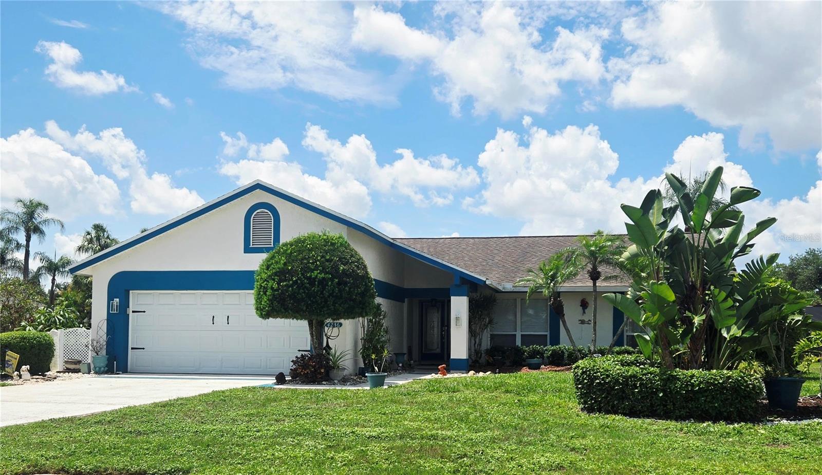 Don't miss out on this Awesome Pool Home on a Spacious almost 1/4 Acre Landscaped Corner Lot! Relax and Entertain in the Private Lanai overlooking the Large Enclosed Very-Well maintained Oversized Pool with a Bar and extra seating, along with a large Ceiling Fan, Fridge, TV, and plenty of cabinet space! The Pool Deck continues for more seating and your Grill. The Pool Cage was replaced in 2021 and is all up to code. A new Pool Heater was installed in 2023 to enjoy throughout the year. There is a Propane Tank on the premises that feeds the Pool Heater and Fireplace. Swim with the Dolphin on the bottom of the pool, then use the convenient shower to rinse off. This three-bedroom  home is all the space you need and has a spacious Living Room with a Propane or Wood-Burning Fireplace that overlooks the Dining Room while entertaining Guests. The Sliding Doors open up all the way to enjoy natural air coming in. The Primary Bedroom is very spacious overlooking the pool with Sliding Doors to sneak out for a swim. The En-Suite Bathroom has a large Walk-In Closet, Dual Sinks, plenty of Cupboard Space, and a Private Commode and Ceramic Shower. The Second Bedroom on the other side is a nice size with a large closet with the Second Bath around the corner. The Bed is actually a trundle bed and can be put back as such.  The Third Bedroom was converted from an Office/Music Room and has a Counter/Desk area for your Printer, Router, and Modem, along with adding a stool. Enjoy the Eating Space in the Kitchen with three windows that overlooks all of the wonderful Landscaping. There are two Pantries and a front Closet. Underground Sprinklers help with making it look beautiful. This Home backs to another home, but the Hedges make for a Private Setting. There is plenty of storage in the spacious garage with enclosed shelving along one side and a pull-down ladder to store lots up in the attic. The home was freshly painted in 2024. The current Owners are only the second Owner of this beautiful home and have lived and maintained it for 33 years! Don't Miss Out!