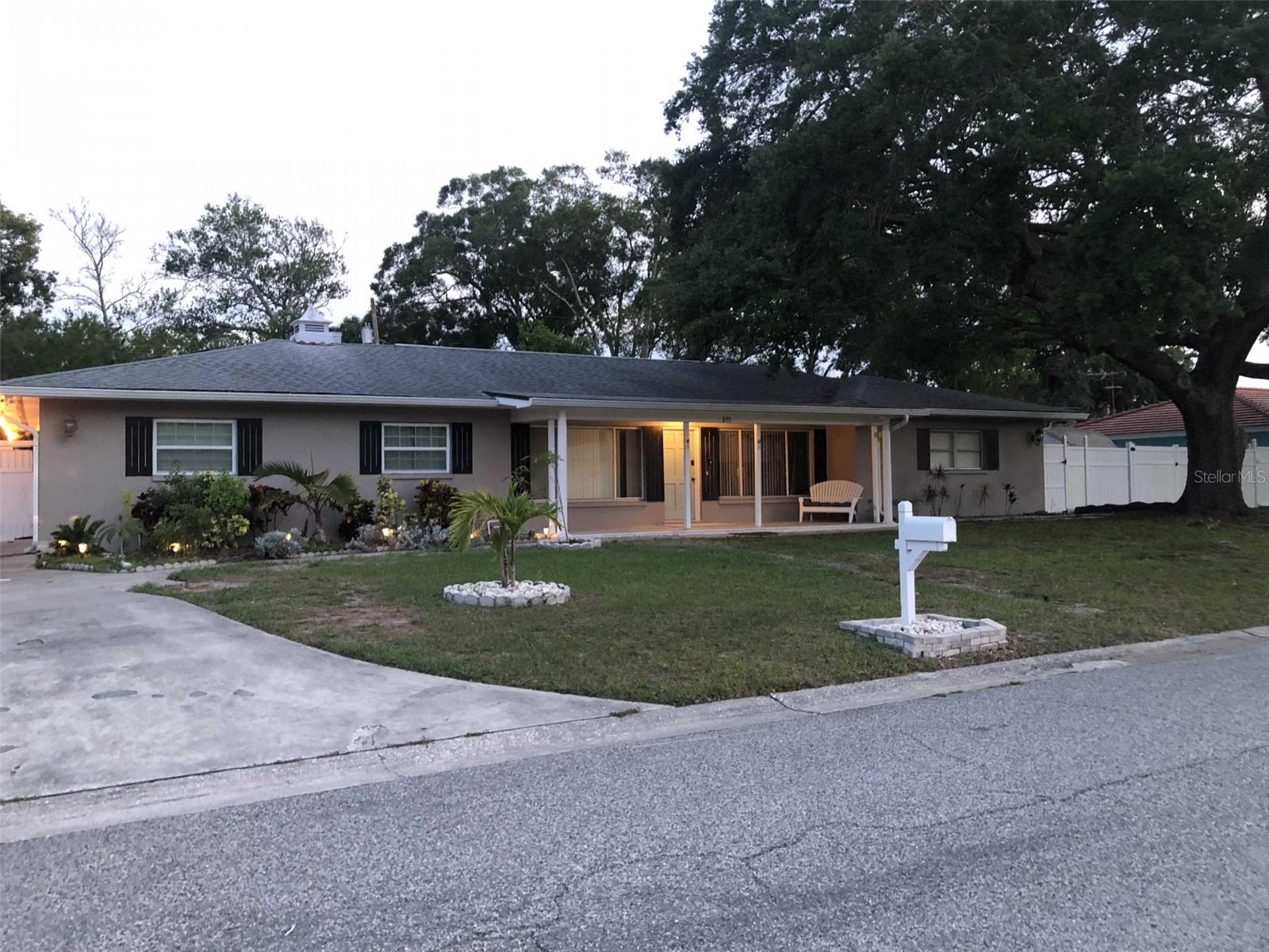 One of a kind bright, spacious and upgraded split-plan large SF house on a Golf Cart accessible street, in the beautiful Dunedin!  This rare find 4 bed/3bath solar-powered house is perfect for household with grown litle ones  or multi-generations or work-live-home business arrangements while providing plenty of privacy, play, and serenity spaces. Entering through Marble-paved covered front porch, what meet your eyes is luxury laminated wood floor throughout living, dining and a sunroom to enjoy your morning coffee in. The kitchen features Santa Cecilia granite counter top bar, large island, raised panel cabinets, built in wine rack, premium travertine tile floor, LED recess ceiling lights and oil rubbed ambiance lighting, electric smooth surface cooktop and all Frigidire stainless steel appliances. Four spacious bedrooms can accommodate a King bed each with built in closets. Master Bedroom suite has a full bath/shower combo with Jacuzzi tub, a washer/dryer combo and marble vanity sink; Bath 2 features spacious walk-in shower and santa cecilia countertop. Bath 3 has upgraded double-sink marble sink, heated Jacuzzi shower/bathtub, large mirror over iced quartz countertop, washer/dryer and plenty of closet space.Corner double lot with vinyl fence over 1/3 acre double lot, with matured trees, three drive-in gates and plenty room to park your toys! A 6-minute bike stroll - 0.9 miles away from downtown Farmer's Market, easy access to sunset on the pier!
