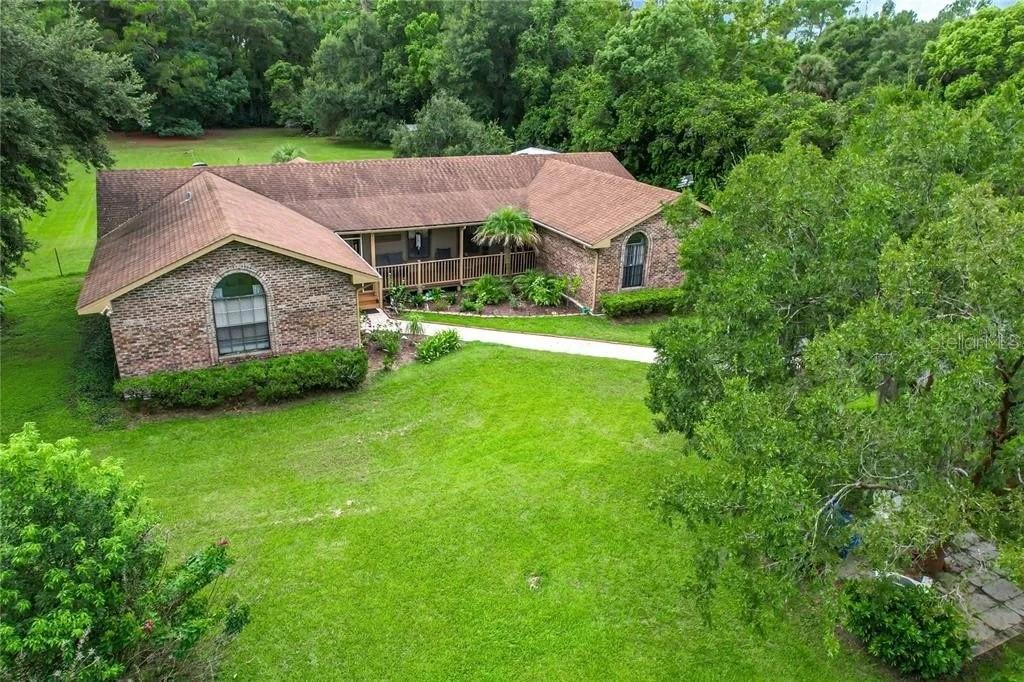 Welcome to 17444 East Road, Umatilla, FL 32784—a spacious 3-bedroom, 2-bathroom home situated on just over one acre in a peaceful setting bordering the Pine Meadows Conservation Area. Offering a desirable split between indoor comfort and outdoor space, this property features both a living room and a separate family room, providing plenty of flexibility for entertaining, relaxing, or creating a home office or hobby space.

Recent updates include a brand-new A/C system installed in 2025, helping provide comfort and efficiency for years to come. The home also features an attached two-car garage and a fully fenced backyard, perfect for pets, play, gardening, or simply enjoying your private outdoor retreat.

Nature lovers will appreciate the property's unique location directly adjacent to the Pine Meadows Conservation Area, where miles of scenic trails, abundant wildlife, and a canal with a newly installed boat ramp provide endless opportunities for outdoor recreation. Enjoy the tranquility of country living while remaining conveniently located near shopping, dining, schools, and everyday conveniences. Although carrying a Umatilla address, this home sits on the border of Eustis, providing easy access to both communities.

If you're looking for space, privacy, and a connection to nature without sacrificing convenience, this property is one you won't want to miss. Schedule your private showing today!