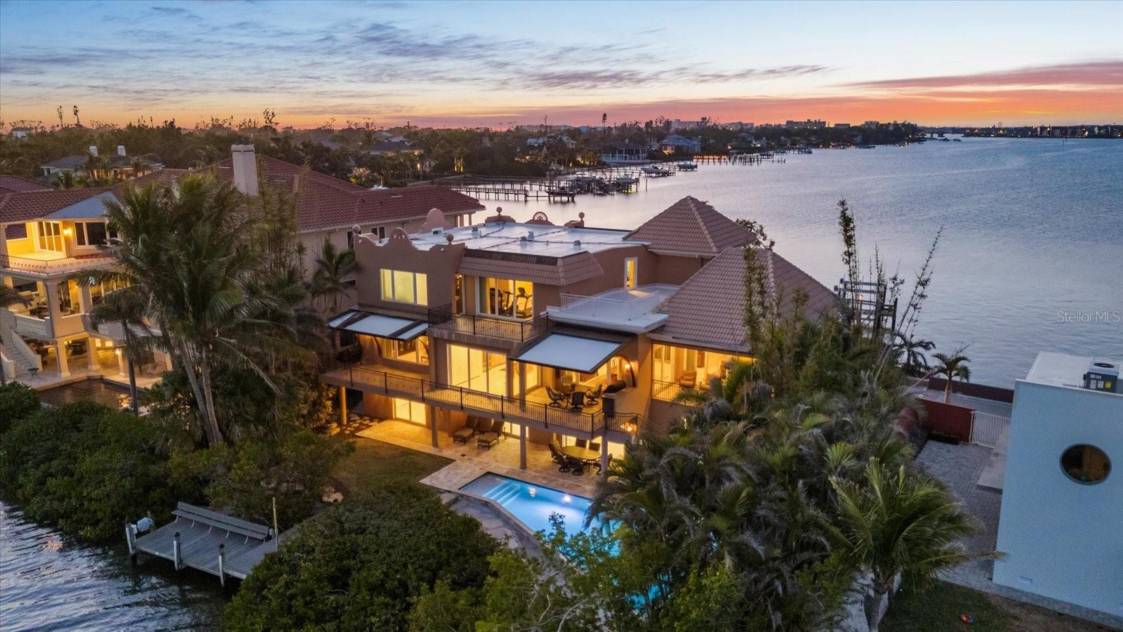 Welcome to 1364 Point Crisp, a breathtaking waterfront home on one of the most private and interesting streets on Siesta Key. With only seven homes on this secluded section of road, you’ll enjoy peace, quiet, and incredible views of Little Sarasota Bay and the Intracoastal Waterway. Watch sailboats glide by or fishermen return from a great day out in the Gulf. This home is a boater’s dream, featuring a 16,000# boat lift and a 10,000# personal watercraft lift not to mention a separate day dock and kayak Launch in the back yard. The heated saltwater pool was custom built and features a spacious deck, and plenty of room to entertain family and friends. Relax on one of the two large second-floor balconies with an outdoor grill area and roll-down screens—perfect for enjoying a glass of wine while watching the sunset. Other features include: a 100KW Kohler commercial backup generator powered by natural gas, Impact-rated doors and windows, well water for irrigation and city water access at multiple points, including the dock. Six climate-controlled garage spaces plus tons of extra storage on the first level, with easy access to the backyard and pool. Inside, with an elevator serving all levels of the home, you’ll find 4 spacious bedrooms, 5 full bathrooms, and a modern kitchen with a Sub-Zero refrigerator, Thermador induction cooktop, and GE Monogram appliances. The wet bar includes a beverage fridge and extra storage—perfect for entertaining. This home has been meticulously maintained and offers countless hidden conveniences that make life easier. Don’t miss your chance to own this incredible waterfront retreat!