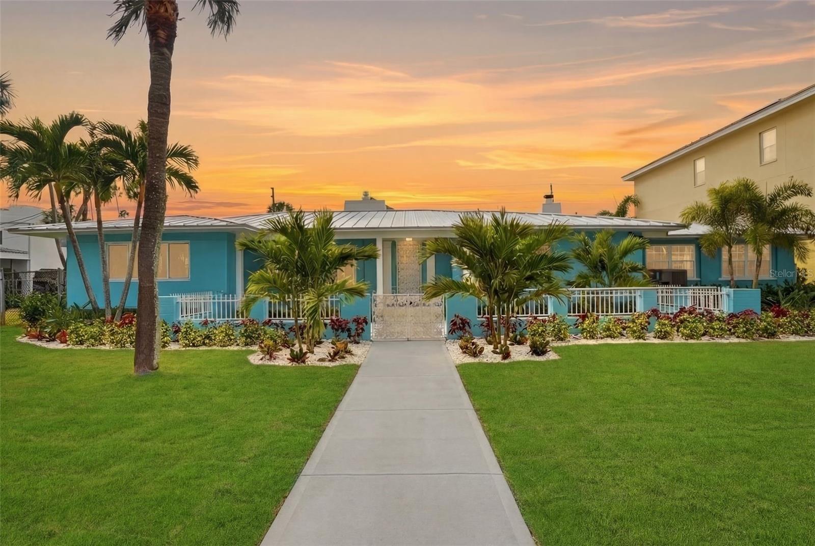 A truly rare offering in the heart of Pass-a-Grille: A generational compound that sits on an exceptionally large parcel comprised of 2 and a half lots. Positioned on luxuriously landscaped tropical grounds exceeding 0.34 acre in one of the most desirable neighborhoods on the Gulf Coast.This magnificently remodeled 3-bedroom, 3-bath residence includes a spectacular in-law suite with its own private entrance—perfect for guests or extended family.
Meticulously renovated to preserve historic charm while embracing modern luxury, the home showcases a dramatic living room with soaring vaulted ceilings and a striking double-sided fireplace, creating a warm and inviting atmosphere for both relaxing and entertaining. The bright, expansive great room—with its dedicated wet bar—offers seamless additional space for gatherings and effortless hosting.The beautifully updated kitchen is spacious and functional, complemented by an oversized laundry room and room to customize to your vision. Other recent improvements include a brand-new roof, new A/C and heating systems, fully renovated bathrooms, gorgeous new flooring throughout, sidings, windows, fixtures and all-new landscaping—delivering both peace of mind and exceptional curb appeal. A two-car garage, covered porch, and extraordinary oversized yard provide ample space to design your dream pool or simply enjoy outdoor living at its finest. Just steps from the stunning sandy beach, this home is perfect for year-round Florida living or as a luxurious vacation retreat.
Pass-a-Grille is widely regarded as the crown jewel of Tampa Bay's barrier island communities. Occupying the southernmost tip of St. Pete Beach on a narrow peninsula flanked by the Gulf and Boca Ciega Bay, it is one of the few remaining beach communities in Florida where condo towers are simply absent, replaced instead by historic cottages, brick-lined streets, and a walkable village centered around the storied 8th Avenue corridor. With perennially award-winning white sand beaches, boutique dining, art galleries, and a marina at your doorstep — yet just 20 minutes from the cultural epicenter of downtown St. Petersburg — it is the rare place that feels like an island out of time while offering everything a refined coastal lifestyle demands.
