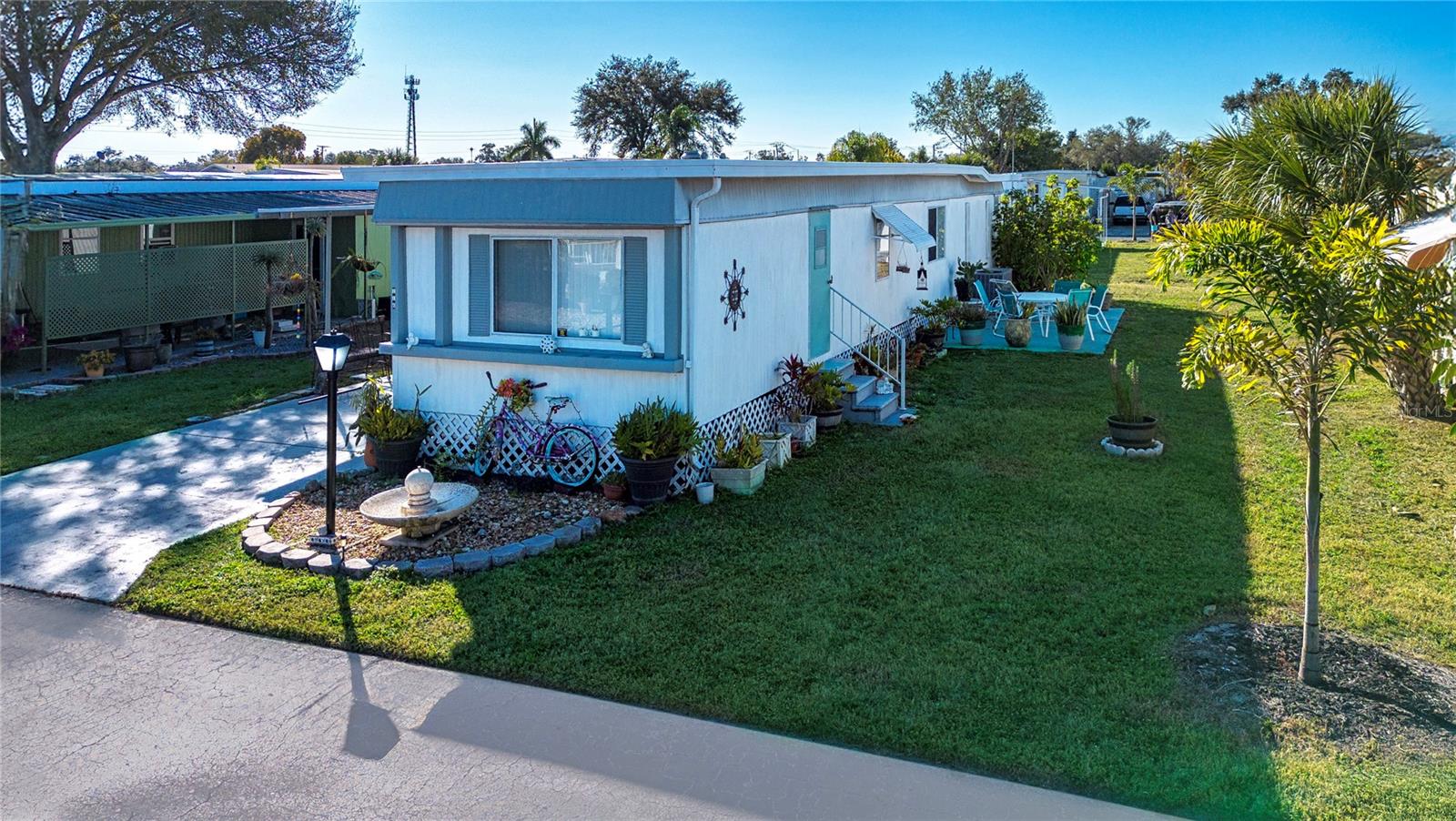Turn Key option, 2BR/2BA located in Skyway Village Co-Op, age qualified community. Featuring updated AC, roof, washer, dryer, LVP flooring throughout. Features a split en-suite floor plan, includes convenient inside laundry. Sold furnished, new leather sofa, making this home truly move-in ready. Enjoy the oversized lanai—perfect for relaxing or entertaining, additional storage, and separate workshop area. This golf-cart-friendly community offers a clubhouse, pool, shuffleboard, and an active social calendar. Ideally located near Skyway Fishing Bridge, medical facilities, shopping, dining, places of worship, with easy access to I-75 and I-275, nearby airports, Gulf beaches, and local attractions. Affordable living at its best.
