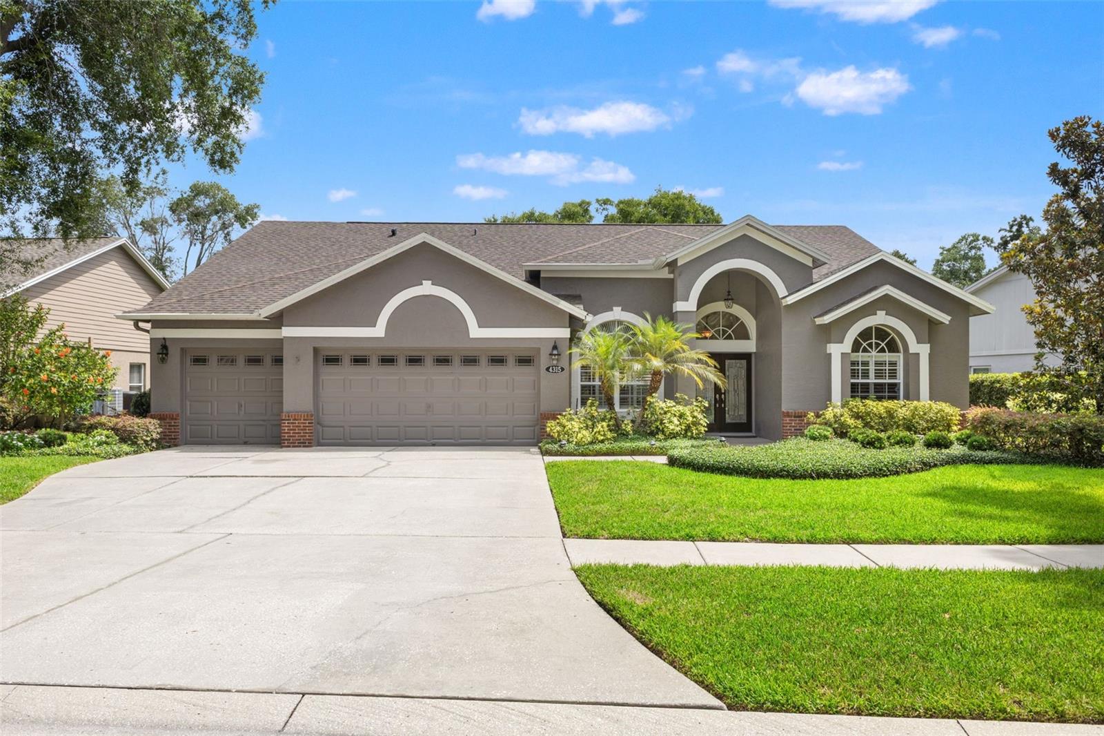Welcome to Casey Lake Manors, an established community known for its beautiful tree-lined streets, mature landscaping, and prime location within the highly desirable Carrollwood school district.  Seldom does a home of this caliber become available in this area.  This meticulously maintained residence, built in 1996, offers a serene backdrop of Casey Lake, with water views visible from nearly every room.  A manicured front yard, freshly painted exterior, brand-new roof, and an extra-wide driveway leading to a three-car garage set the stage for what awaits inside.  A formal foyer welcomes you into the home, complemented by a sitting room, a formal dining room, a dedicated office behind French glass doors, and a desirable split-floor-plan. The generous owner's suite offers private patio access, a spacious walk-in closet, and an updated bathroom featuring a large walk-in shower and soaking tub.  Three additional bedrooms and two full bathrooms are located on the opposite wing of the home, providing privacy and comfort.  The updated kitchen features stainless steel appliances, beautiful granite countertops, and peninsula seating. Prefer a breakfast table? There's space for that too.  The kitchen flows naturally into the family room, where a timeless brick fireplace anchors the space, adding warmth, character, and architectural charm.  Whether you're enjoying a quiet evening at home or hosting friends and family, this home is designed for comfortable living and entertaining.  Multiple sliding glass doors create a seamless connection to the patio, making al fresco dining and gatherings effortless. Throughout the home, abundant natural light and plantation shutters create a bright, inviting atmosphere while maintaining privacy.  Engineered hardwood flooring adds warmth and sophistication, completing the home's inviting atmosphere.  Enjoy Florida summers in your private pool and spa, then unwind on cooler evenings in the hot tub. The covered patio, screened pool enclosure, professionally landscaped grounds, and serene backyard setting create a private outdoor retreat you may never want to leave.  For added peace of mind, the home is equipped with a hurricane shutter over the primary bedroom slider, providing a safe space for you and your family during severe weather.  A generator hookup at the electrical panel further enhances the home's preparedness and functionality.  Pride of ownership is evident throughout, with significant updates including a new HVAC system (2022), roof (2026), and pool equipment (2023), along with meticulous exterior maintenance. Fresh exterior paint and regularly scheduled pest control, lawn care, and pool service by professional companies reflect the exceptional care this home has received. Reach out and schedule your private presentation today!