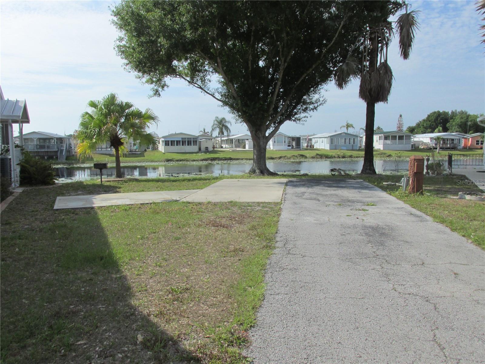 Watch the sunrise from this great shaded WATERFRONT RV lot, the ONLY waterfront lot available at beautiful Saddlebag Lake Resort. It's the perfect location to park your motor home for the winter, or live here year round, no need to go from park to park! There's room for a picnic table next to your barbeque grill. You can make it even more permanent by placing a manufactured home on the lot.  The lot has 100 amp service and water & sewer hookup. Launch your boat from your back yard and spend the day on the lake. Enjoy a swim in the sparkling community pool, then relax in the large hot tub. Make new friends and participate in planned activities at the clubhouse. Get ready for retirement living at it's finest in this 55+ gated community with security, including shuffleboard, tennis and pickle ball courts, rec room, saunas, fitness center and more. Laundry facility and post office on site. There's even a dog park at the back of the resort, and a driving range. HOA includes water, trash pick-up, and sewer. Call for your private tour today, and stay for a lifetime!