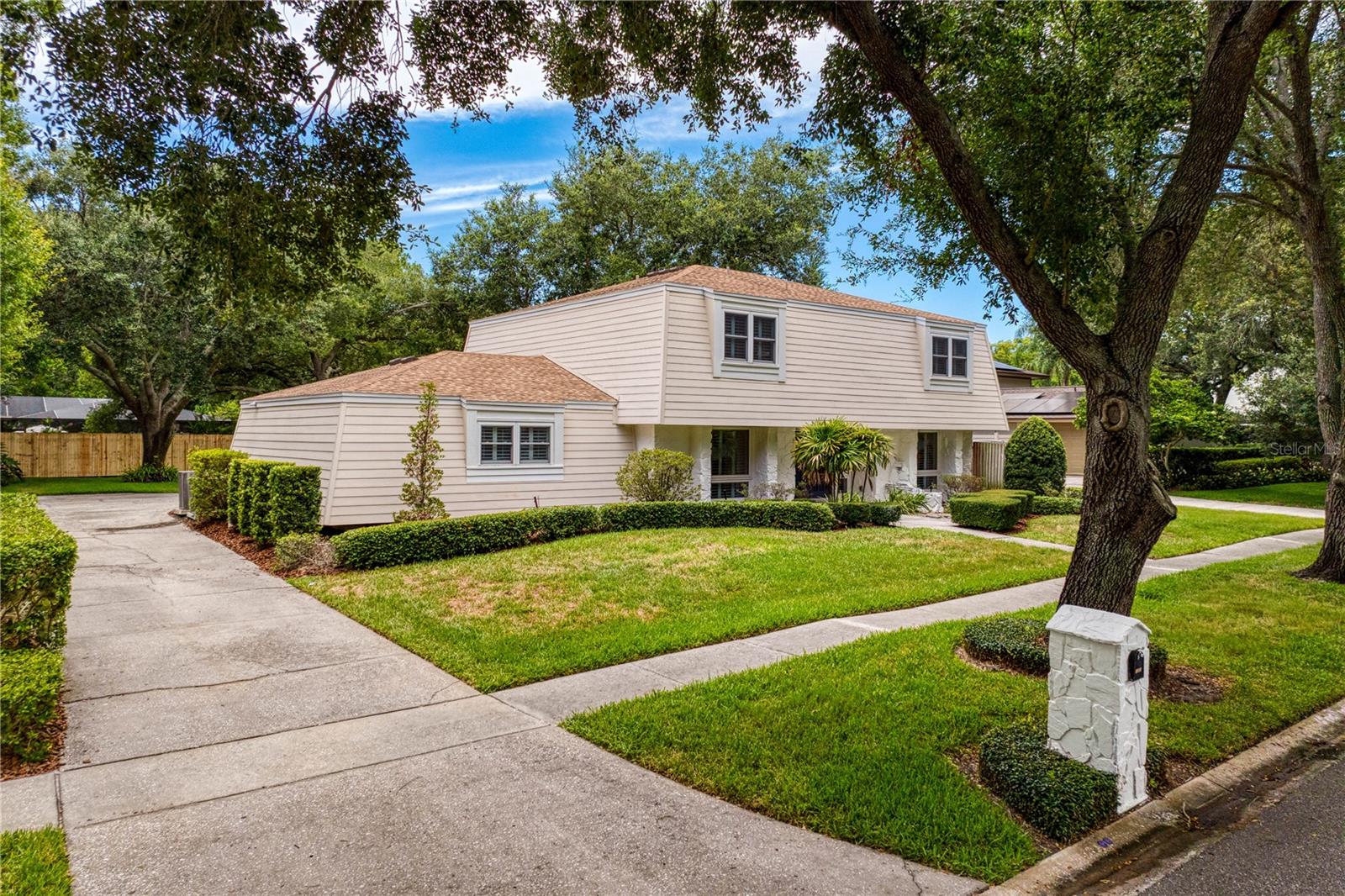 This fully renovated 4 bedroom, 2.1 bathroom pool home in the golf course community of Carrollwood Village blends classic charm with modern designer finishes and beautiful millwork throughout. With hurricane windows, newer roof (2022), AC (2019) and hot water heater (2025), there is nothing to do but drop your bags! A center hall foyer greets opens to a living room which has a wall of built-ins. The formal dining room leads to a butler’s pantry with a wine fridge and wet bar. The stunning kitchen has quartz counters, a pantry, breakfast bar and open shelving. The kitchen opens to the family room which has an electric fireplace flanked by built-ins. A laundry room leading to the oversized two-car garage and a half bathroom are also found on the first floor. Upstairs are four large bedrooms. The primary bedroom has a walk-in closet and en-suite bathroom with double vanity and tiled shower. Sliders from the family room open to the newly-tiled screened lanai which has a pass-through counter to the kitchen. The private, fenced backyard has a private pool, paver patio, and beautiful manicured landscaping. This home also has plantation shutters and wide-plank flooring throughout and built-in storage in the garage. Situated on a tree-lined street of beautiful homes and is located in easy proximity to shopping and restaurants, top-rated schools and highway access.
