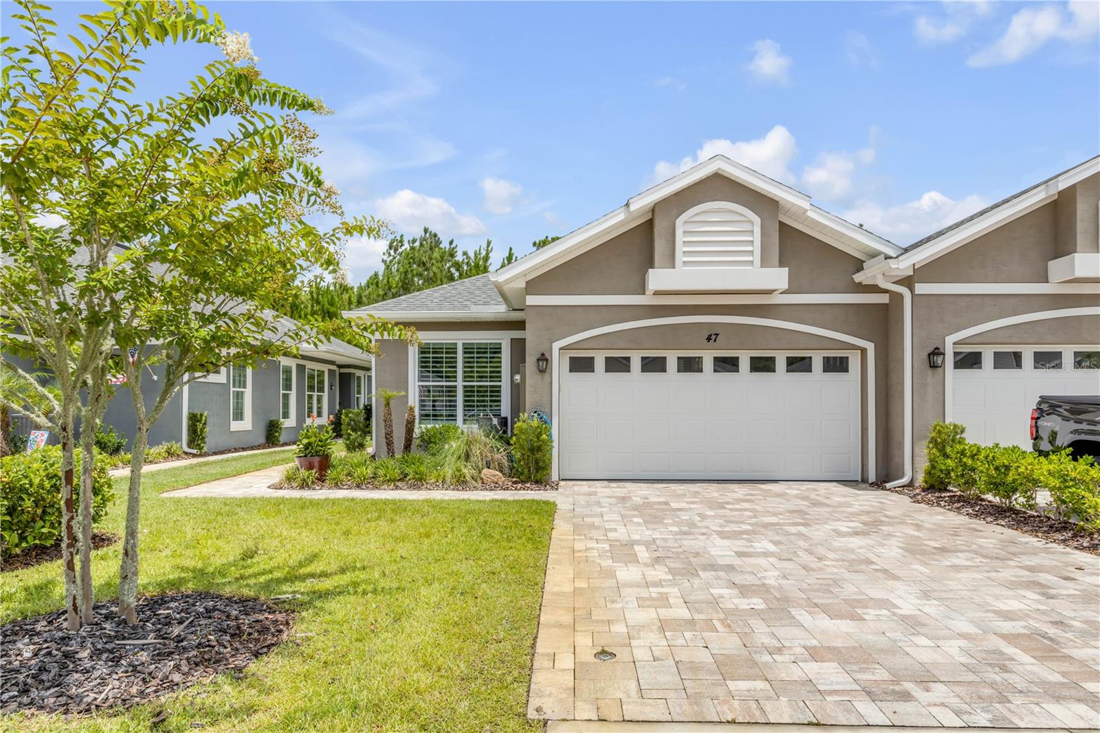 Welcome to effortless, maintenance-free living in the highly sought-after 55+ community of Huntington Villas at Hunters Ridge! Built in 2022, this beautifully upgraded 2-bedroom, 2-bath home plus a versatile flex room offers the perfect blend of style and functionality. The open-concept split-bedroom floor plan features soaring ceilings, abundant natural light, and continuous flooring throughout. The spacious kitchen boasts stone countertops, upgraded stainless steel appliances, abundant cabinetry, and overlooks the living and dining areas, making it ideal for entertaining. Thoughtful owner upgrades include shiplap accent walls in the primary bedroom and bath, custom decorative dining room accent walls, and a finished two-car garage with gorgeous epoxy flooring. Qualified VA buyers may assume the existing loan at an attractive 4.6 interest rate, and furnishings are negotiable with an acceptable contract.

Enjoy a true lock-and-leave lifestyle with exterior maintenance handled for you, giving you more time to enjoy the exceptional community amenities, including a private residents' pool, additional resort-style pools, clubhouse, fitness center, pickleball and tennis courts, walking and jogging trails, playground, dog park, and beautifully maintained grounds. Conveniently located just minutes from shopping, dining, healthcare, golf courses, I-95, US-1, and the area's beautiful beaches, this move-in-ready home offers the perfect combination of comfort, convenience, and the Florida lifestyle.