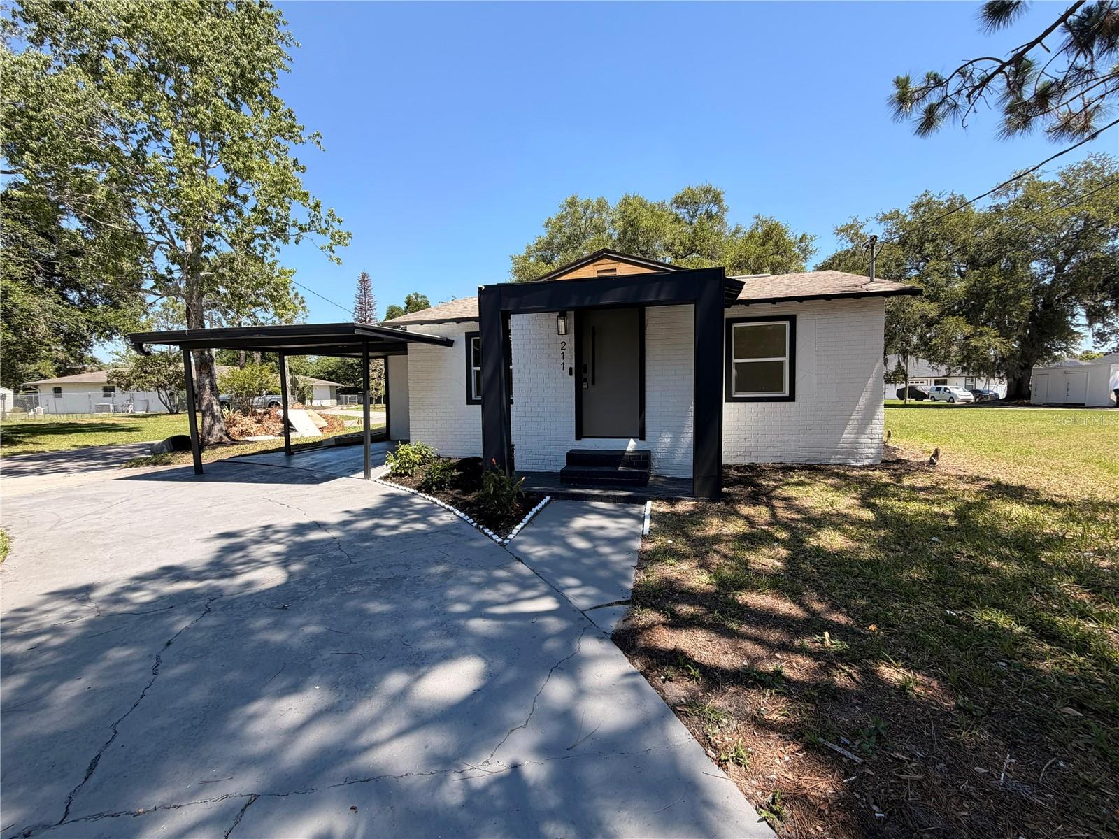 FULLY RENOVATED IN 2026 | 4 BEDROOMS | 3 FULL BATHROOMS | NO HOA | TWO PRIVATE SUITES | CORNER LOT

Welcome to 211 Bayshore Drive, a fully renovated residence that combines modern finishes, a functional layout, and a convenient location near the heart of Orlando.

Situated directly across from Roosevelt Martin Park and the lake within the park, this property offers open views of green space and immediate access to recreational areas, creating a unique sense of openness and connection to the outdoors.

The home features 4 bedrooms and 3 full bathrooms, including two private suites with en-suite bathrooms. One of the suites includes a spacious walk-in closet, making the layout ideal for larger families, multigenerational living, guests, or those who need additional space for a home office.

The open-concept design showcases a modern kitchen with quartz countertops, a large center island, soft-close cabinetry, and a complete appliance package including refrigerator, built-in cooktop, oven, microwave, range hood, and dishwasher.

The comprehensive 2026 renovation includes new windows, new HVAC system, new plumbing, new electrical wiring, new water heater, new flooring throughout, updated lighting, and fresh interior and exterior paint.

Situated on an approximately 10,362-square-foot corner lot, the property offers a rare feature for this area: parking for up to 8 or 9 vehicles, in addition to a covered two-car carport and a detached storage building.

The location provides quick access to Downtown Orlando, Orlando Health, Camping World Stadium, Kia Center, major employment centers, shopping, dining, and key transportation corridors including I-4 and SR-408.

With no HOA, a complete renovation already completed, and a highly functional floor plan, this move-in-ready home offers an excellent combination of space, convenience, and value in a central Orlando location.

Schedule your private showing today!