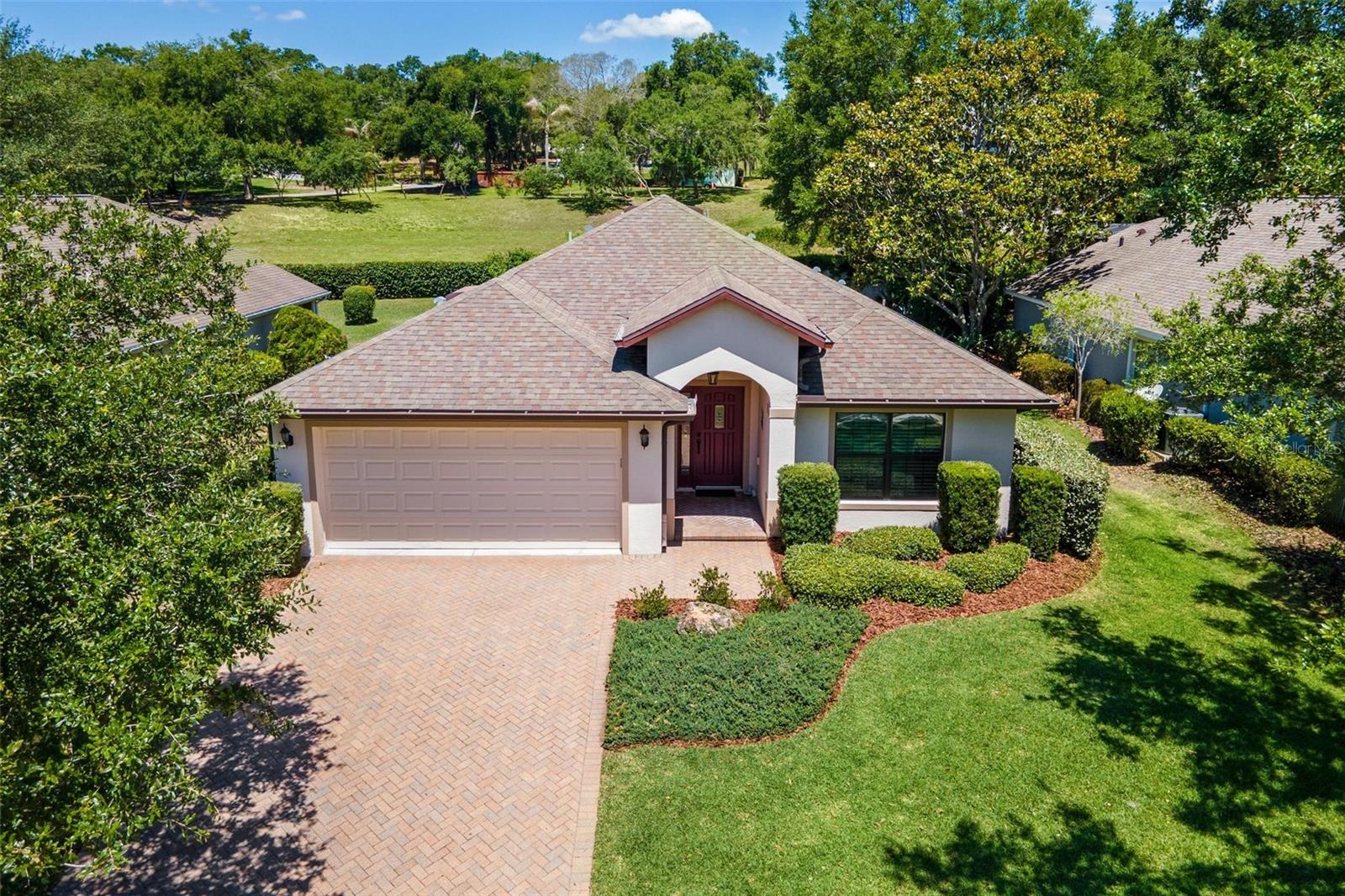 MOVE-IN READY and fully furnished… just bring your suitcase and start enjoying the lifestyle you’ve been dreaming about! Golf cart conveys, and the seller will even pay the $2,500 clubhouse initiation fee for the buyer, making this an incredible opportunity to step right into resort-style living (enjoy Fitness Room, Heated Pool, Raquet/Tennis/Pickleball, Activities & more) in a guard-gated 24/7 "ALL AGE" golfing community. From the moment you arrive, the brick paver driveway and welcoming foyer set the tone for this beautifully maintained home. The spacious kitchen is designed for both comfort and entertaining, featuring granite countertops, abundant cabinetry with built-in Lazy Susan and deep drawers, closet pantry storage, and a cozy dinette area overlooking the heart of the home. The kitchen flows seamlessly into the great room and formal dining area, creating the perfect setting for gatherings with family and friends. Relax and unwind on the large, covered lanai with an additional birdcage screened porch with patented Screen Room Drains showcasing stylish stamped concrete flooring and a private backyard retreat perfect for morning coffee! The split bedroom design offers privacy for guests, while the primary suite features a custom walk-in closet system and spacious bath with dual raised vanities, Corian countertops, oversized walk-in shower, and separate water closet. Additional highlights include an inside laundry room with cabinetry and washer and dryer that convey, oversized two-car garage with custom built-in cabinets plus utility sink, and sturdy block construction for peace of mind. Enjoy the benefit of public sewer (no septic) with a special feature of a "Wunder Cover" in driveway for access! This home is priced to sell and offers the perfect blend of comfort, convenience, and carefree Florida living. Golf Membership is available for additional Fees. Don’t miss your chance to make this beautiful home yours… schedule your private showing today before it’s gone!
