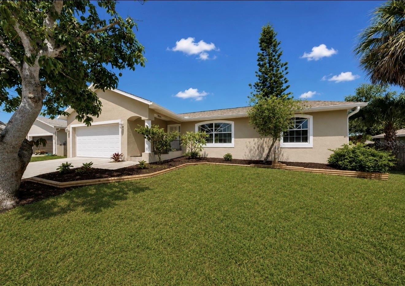 STEP UP and into your next Apollo Beach home! This elevated location sits high and dry and the home is move-in ready! This charming 3-bedroom, 2-bath home has been thoughtfully refreshed with a new roof, fresh interior and exterior paint, and new stainless steel appliances. The open-concept floor plan creates a welcoming space for everyday living and entertaining, while abundant natural light enhances the home's bright and airy feel. The spacious primary suite provides a comfortable retreat, and one of the secondary bedrooms features a built-in desk, making it ideal for remote work, studying, or creative pursuits.  The expansive backyard offers plenty of room for summer barbecues, outdoor gatherings, gardening, or future additions. Mature trees and refreshed landscaping add to the home's curb appeal, while the absence of HOA restrictions means recreational vehicles, boats, and commercial vehicles are welcome. The homeowners and flood INSURANCE quotes are truly affordable as well! Conveniently located less than one mile from waterfront dining, boat ramp, and Tampa Bay nature parks, this property combines freedom, functionality, and a desirable coastal lifestyle.