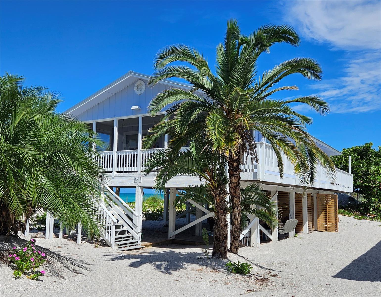 This charming 3-bedroom, 2-bath beach home is situated on Little Gasparilla Island, a unique bridgeless barrier island off the coast of the Cape Haze Peninsula. Accessible only by private boat or water taxi, the island is just a short 10-minute ride across the bay, making it an ideal location for those seeking tranquility and a true escape from the busy mainland. Relax and unwind in this peaceful retreat, where stress fades with the sound of the waves and the gentle tropical breezes. There is a community dock to use with membership and deeded beach access. The screened-in front porch offers stunning views of the beautiful blue-green waters of the Gulf, creating the perfect spot to start or end your day. Just steps away, the uncrowded beach is ideal for collecting seashells and shark’s teeth, swimming, or simply soaking up the sun with a good book. From 2025 to the present, the home has undergone several significant improvements. These include a new metal roof, installation of a new air conditioner, construction of a new storage shed under the home, new vinyl flooring, removal of popcorn ceilings in most rooms, and fresh paint inside and out. Enjoy gulf views from the kitchen, living room, and all bedrooms. Imagine waking up each morning to breathtaking views right from your bed. This home can comfortably sleep 10 people. One bedroom has a built-in murphy bed and two sets of bunkbeds. Beneath the home, there is a deck area perfect for relaxing with friends and family. Little Gasparilla Island is a true retreat, with no grocery stores, restaurants, or shops on the island itself. However, a variety of delightful dock-side restaurants are easily accessible by boat. The surrounding waters are renowned for excellent fishing, with opportunities to catch redfish, snook, snapper, trout, and more. As evening falls, neighbors often gather by the water’s edge to watch the sunset, ending another peaceful day in paradise. Discover this lovely home and embrace the unique lifestyle that island living offers. Experience the serenity, beauty, and sense of community that define life on Little Gasparilla Island.
