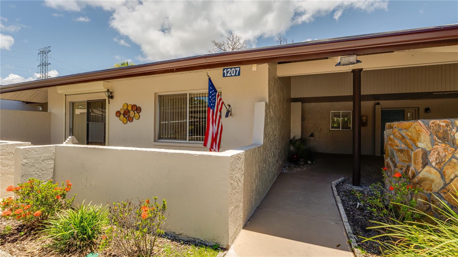 THIS IS A FANTASTIC OPPORTUNITY TO MAKE THIS 2 BEDROOM 2 BATH FULLY FURNISHED (minus personal and 2 furniture items) YOUR VERY OWN!  NEW HAVEN IS ABSOLUTELY ONE OF THE BEST +55, PET FRIENDLY communities which has it all.  TENNIS COURTS, PICKLE BALL COURT, HUGE HEATED POOL + SPA, FITNESS ROOM...PLUS...A PLACE TO PARK YOUR RV OR BOAT AT NOW EXTRA CHARGE!  New Haven is centrally located, tucked away LESS THAN 1 MILE from LARGO CULTURAL CENTER, MINUTES TO OUR AWARD WINNING BEACHES + SHOPPING AND DINING.  As you enter you will immediately notice the NEW beautiful LUXURY FLOORING + the OPEN FLOOR PLAN with more than ample space (12x22) with an abundance of NATURAL LIGHT.  Just off the living area, through sliding glass doors which have HURRICANE SHUTTERS, you will enjoy your morning coffee on your OVERSIZED, SCREED back patio.  Kitchen has newer cabinets and appliances, RO in the kitchen with full unit water softener, FULL UTILITY ROOM just off the kitchen, front load, FULL SIZED  WASHER + DRYER come with the unit.  MASTER BEDROOM IS WELL SIZED (12X16) with sliding glass doors which also have HURRICANE SHUTTERS, that leads out to the open front patio, WALK IN CLOSET + PRIVATE FULL BATH.  AC new 2026. Water Heater 2024.  ASSIGNED COVER PARKING right out your front door with PLENTY of guest parking.  New Haven is very strong financially, fully funded, known for its PARK LIKE ATMOSPHERE, METICULOUSLY well maintained grounds and a VERY FRIENDLY COMMUNITY.  Whether you are looking for a your new home or a winter retreat, New Haven is one of the best communities in Largo!  this beautiful updated, FURNISHED condo it the value in NEW HAVEN WELCOME HOME TO YOUR RESORT STYLE LIVING!