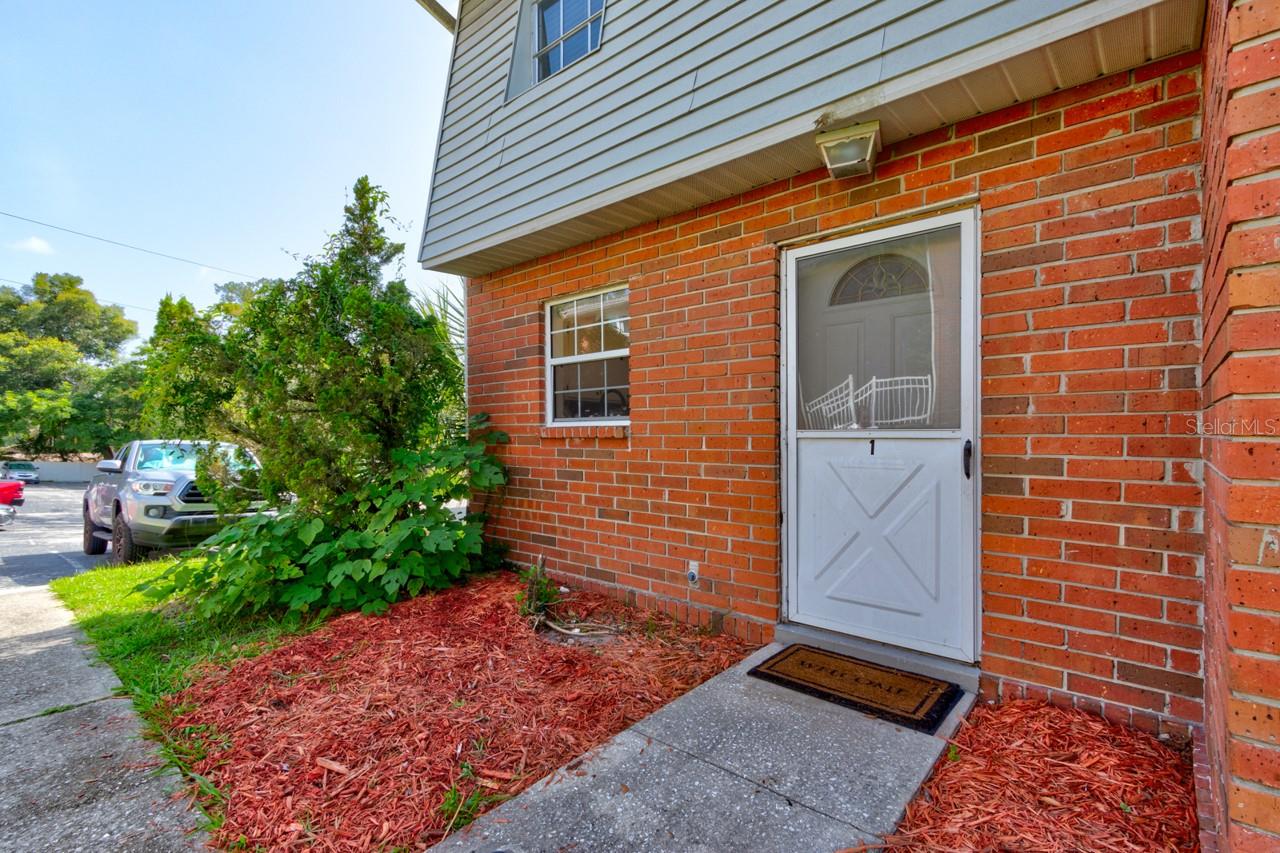 Welcome to this ideal end-unit townhome where the charm of Historic DeLand begins. Perfectly positioned beside Freedom Park and just moments from the heart of downtown, you'll enjoy the best of in-town living without the restrictions of the Historic District. Inside, you'll find an open, light-filled floor plan with upgraded French door sliders leading to a private paver patio—ideal for relaxing or entertaining. Newer A/C & water heater provide added peace of mind. Your dedicated parking space is conveniently located just steps from the unit. The HOA covers lawn care, exterior pest control, exterior maintenance & the roof, making for easy, low-maintenance living. Whether you're looking for a primary residence, investment, or lock-and-leave lifestyle, this home offers comfort, convenience & an unbeatable location.