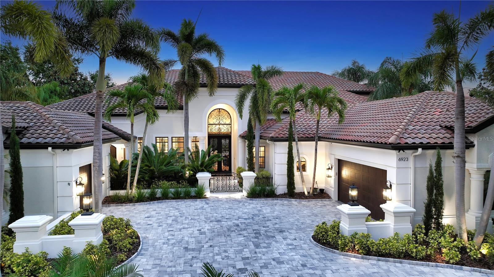 Exquisite, custom Arthur Rutenberg home rivals the best of the best in that Lakewood Ranch!  This Zen like residence boast 8,514 square feet, 6600 of which is air conditioned, is truly an experience with 5 generous size bedrooms, 4 of which are ensuite, a first floor state-of-the-art gym, a second floor climate controlled wine room with iron door, two koi ponds that flank the east and west sides of the home, extraordinary finishes throughout including quartz, marble, limestone, travertine and more.  The gourmet kitchen is open and airy featuring new wood cabinetry, hidden pantry closet, Miele appliances, double refrigerator/freezer, including natural gas cooktop, waterfall quartz countertop, spectacular new lighting throughout and wood butcher block bar seating!  This home is sun filled with transom windows above the sliding doors, allowing the natural light to spill into every room.  All five bathrooms have been transformed with state-of-the-art commodes, under counter lighting, and refined features and finishes. Upon entrance through the double Cantera Iron doors, you will be transported and experience a feeling of calm and serenity.  From the handsome engineered wood floors to the 14-foot ceilings, every inch of this home has been thoughtfully remodeled with the most unique materials and selections.  The primary suite located on the first floor of the west wing, offers a sitting area overlooking the newly resurfaced and retiled saltwater pool.  Window blinds are controlled by remote control with new Sonos throughout!  HVACS and tankless hot water heaters are new!  Garage floor is epoxy paint and has built-in storage units. This home has a whole house generator!  Primary closets are generous with built in cabinetry for efficiency and organization.  Primary bath is one of a kind with free standing tub, dual sinks, shower with two heads, state of the art commode and decorator lighting.  Travel up the staircase to the media room, wine room, fifth bedroom with huge walk-in closet and access to fully remodeled bathroom with walk-in shower.  The view on this masterpiece is like no other view in Lakewood Ranch Country Club.  Relax on the second floor terrace overlooking the beautiful pond and private Legacy Golf Course with mesmerizing skies! The pool and outdoor living space is an oasis of luxury and refinement with beautiful pool with sun shelf and infinity edge spa, panoramic pool screen, travertine decking, wood ceilings, summer kitchen, outdoor shower, pool bath, pool closet and two televisions!  Visit 6923 Westchester Circle where form and function meet luxury.