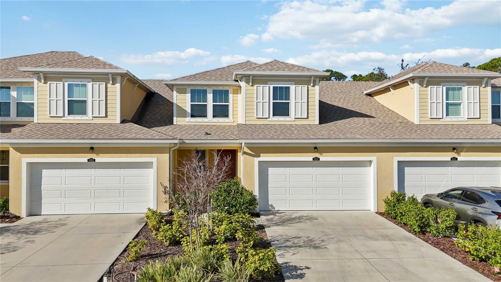 Welcome to this charming and highly sought-after Sandbar 2 townhome by Mattamy Homes, located in the desirable community of Harmony at Lakewood Ranch. This thoughtfully designed residence offers 3 BEDROOMS plus a LOFT, 2.5 BATHS, and an ADDITIONAL 12' x 10' FLEX/STORAGE ROOM, providing a potential for a 4th BEDROOM, HOME OFFICE, game room, or flex space.

Upon entry, soaring VAULTED CEILINGS reaching up to 15 feet immediately enhance the open-concept layout, creating a bright and airy living environment. The home features carefully selected finishes throughout, including QUARTZ countertops, laminate flooring, 8-foot interior doors, and 7" x 22" WOOD-LOOK TILE on the main level.

The kitchen blends sophistication and functionality with quartz countertops, tile backsplash, 42" staggered CABINETRY, stainless steel appliances, and a striking custom BOARD AND BATTEN accent wall. The spacious primary suite offers luxury vinyl flooring, an expansive WALK-IN CLOSET, and an elegantly finished primary bath featuring DUAL-SINK quartz vanity and a tiled shower.

Upstairs, you’ll find two secondary bedrooms, a full bath, a versatile loft, and the additional 12' x 10' bonus/storage room, ideal for work-from-home needs or additional entertainment space. A 2-CAR garage completes the home.

Residents of Harmony enjoy RESORT-STYLE AMENITIES, including a HEATED POOL, outdoor grilling area, FITNESS CENTER, playground, and PET-FRIENDLY walking trails woven throughout the community, making it ideal for ACTIVE LIFESTYLE and pet owners alike.

Conveniently located near The Green at Lakewood Ranch, you’ll have easy access to popular dining, bakeries, coffee shops, shopping, fitness centers, spa, medical offices.

Schedule your private showing today and experience the best of Lakewood Ranch living.