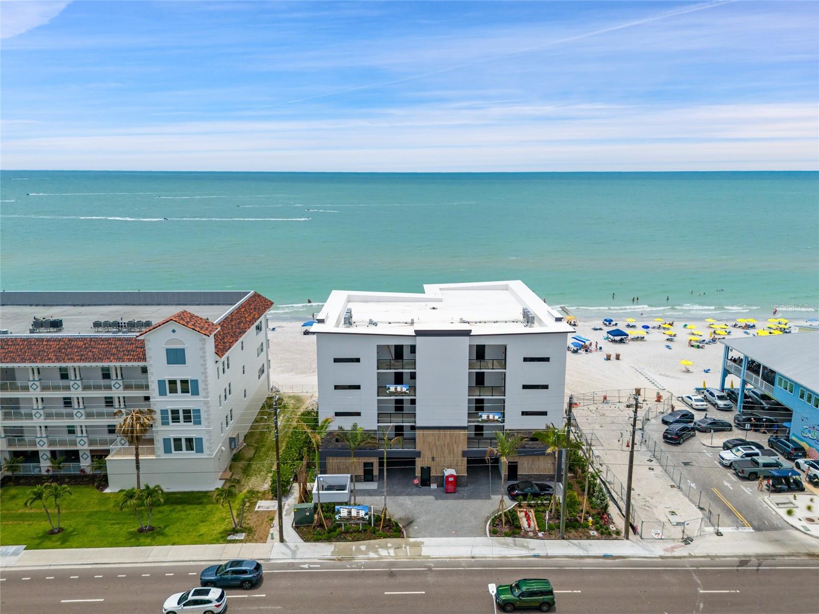 GULF FRONT - Spectacular new building on Madeira Beach. Each unit offers high-end features, an expansive outdoor living area, and direct Gulf views with incredible sunsets. Largest balconies on the beach. Units starting at $2,625,000. This exquisitely designed building will only have 8 units - 2 units per floor, offering an elevator, pool/spa and under building parking. This unit has 2 bedrooms, 3 baths plus a den. Stainless steel appliances, designer backsplash, high-end cabinetry package for kitchen and bathrooms, solid core doors and premium hardware. Engineered wood flooring with sound mat underlay, luxury carpet in 2nd bedroom and den. Large format tile in Master En-Suite, complete with art-deco accent behind the vanity and custom shower floor design. The second bathroom will include luxury details with tub surround and 6” mosaic tile waterfall accent. Hurricane impact windows and sliders. Large covered outdoor living space (808 sq. ft) will include built-in features and porcelain tile. Beachfront pool and spa with large deck, paver parking lot, landscape package with irrigation system, and exterior lighting. Condo docs available. HOA costs, requirements, leasing, etc to be determined.