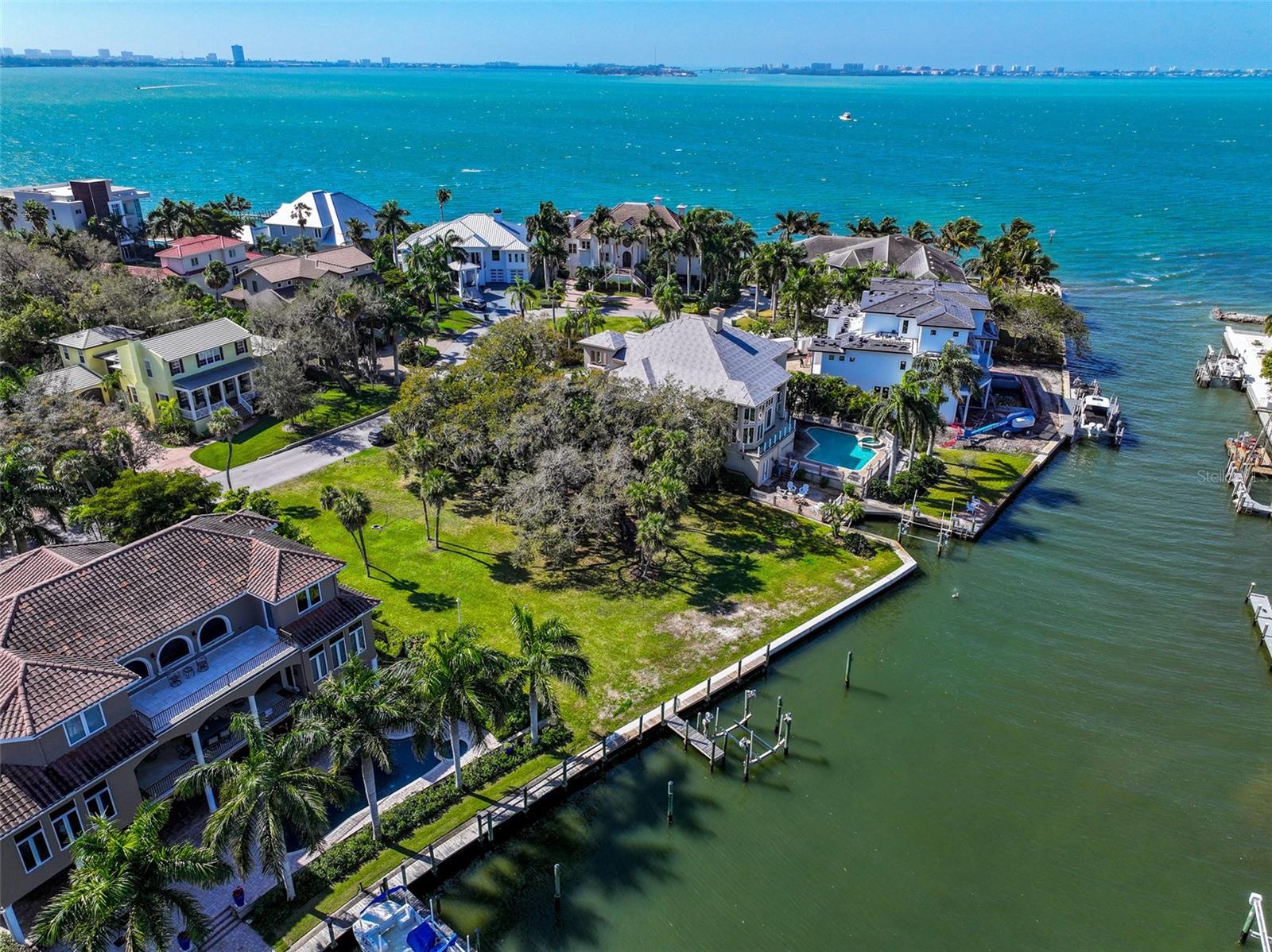 One or more photo(s) has been virtually staged. EXCEPTIONAL WATERFRONT PROPERTY, Directly on Whitaker Bayou just two lots form Sarasota Bay! This gated Whitaker's Lane Lot is .4  acres large and 103 feet of waterfront.  The lot has a new seawall and a boat dock.  The property offers Spectacular views of Whitaker's Bayou and Sarasota Bay.  This gated community is  located just a mile north of downtown Sarasota and is truly in the heart of everything.   Just minutes from St. Armand's Circle and  area beaches and just 3 miles to Sarasota International Airport.  This is a rare opportunity to find a large, waterfront lot  for building  your new  home.    This property is being sold with a complete set of building plans (Virtual Photos can be seen in the listing pictures) which can be altered to your exact taste and style.  The aerial footage shows the views from approximately 45 feet above the ground.