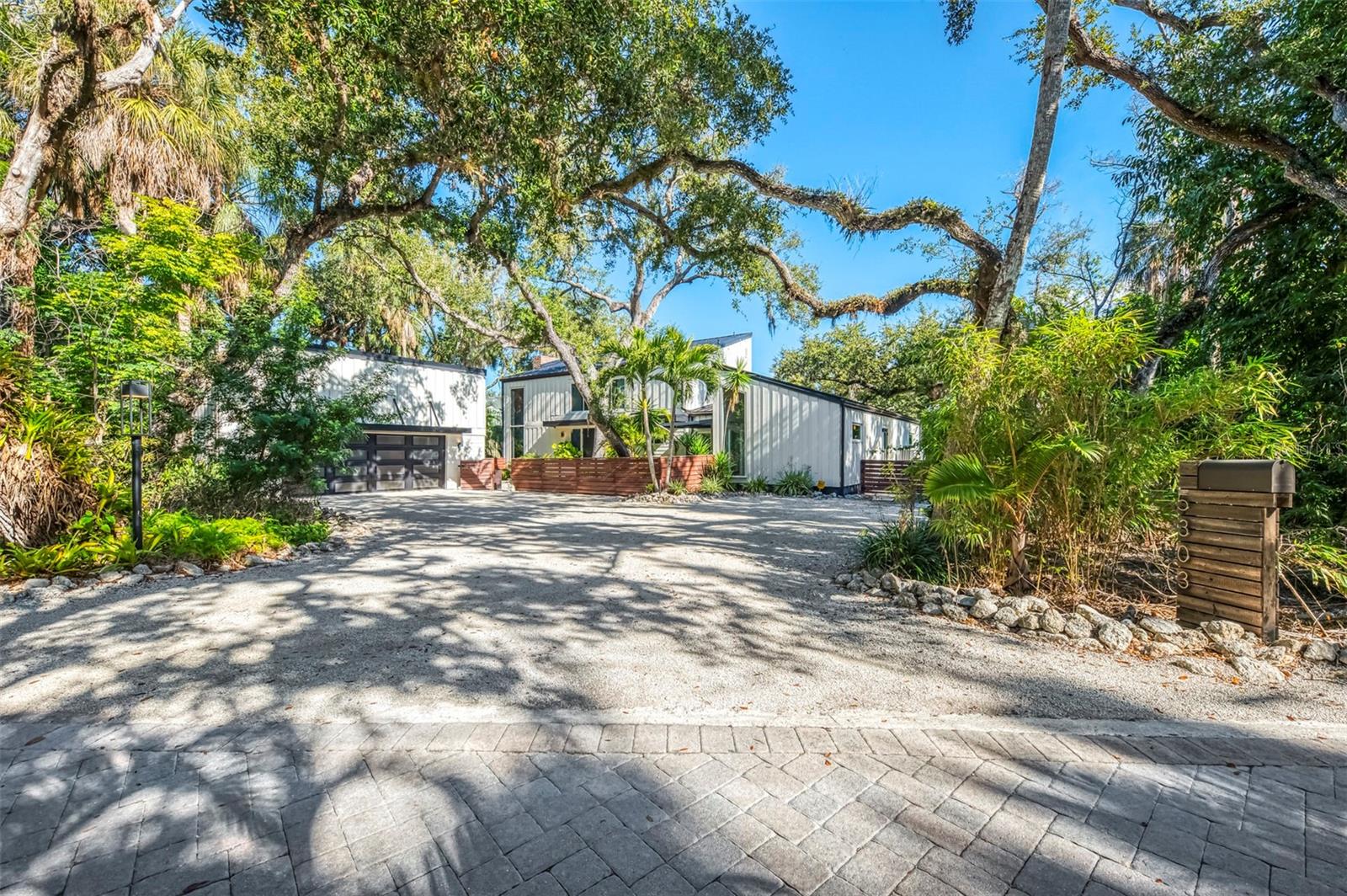 Now is your opportunity to own this waterfront tropical oasis on Siesta Key in the highly sought after exclusive community of Hidden Harbor. Comprised of just 36 homes, Hidden Harbor located on the North end of Siesta Key, is one of the most unique developments in Sarasota with its tropical landscaping reminiscent of old Florida. Most known for its waterfront lots and brick paver streets shaded by a magnificent canopy of lush greenery. This home has been beautifully reimagined to showcase its contemporary design and is situated on over half acre lot enjoying 119’ of deep-water canal front, making this a boater’s dream. The dock spans almost 40 feet and features a 10,000lb boat lift (installed in 2020) and has both electric and water supplies. No bridges to obstruct your journey out to Roberts Bay, which is just a turn of a corner away. The home features a new metal roof (2023), 4 new HVAC units that includes a garage unit (2024), and new hurricane impact sliders and windows (2021). On the inside you will find a floor plan that is flooded with natural light thanks to large sliders and tall architectural style windows that truly bring the Florida landscape inside. The first floor has all new luxury flooring and woodwork, including new solid core doors. The kitchen was recently renovated with European style cabinetry, stone counters, and a luxury Fisher & Paykel appliance package including range hood and induction cooktop. The two light-filled bedrooms on the East side of the home both feature access to outdoor spaces and walk-in closets. The shared bathroom, which also acts as a pool bath with its door to the outside, was renovated with a new seamless glass shower, European style vanity with LED mirror, and all new fixtures and hardware. Throughout the home, you will find restored original fixtures keeping with the home’s integrity. The primary suite dominates the second floor with a loft area, a light filled bedroom that enjoys the cross breeze when both walls of sliding windows are open, and a custom installed closet. There is an updated en-suite bathroom with another seamless glass shower and floating vanity with new upgraded fixtures. Outside the yard is truly a Florida paradise with fire pit area, stunning tropical landscaping with professionally installed low voltage lighting system, pest control misting system, and an impressive heated pool that was resurfaced and upgraded with a travertine deck. This property offers extreme privacy, architectural character and significance, and water views, all within one of the most unique neighborhoods on Siesta Key. The Hidden Harbor canal offers deep water for your boat or sailboat. Enjoy true island life, whether you find yourself relaxing by your pool, boating, fishing, kayaking, and even paddle-boarding all from your property. There is a natural seawall of mangroves, and the riprap was installed by the reputable Duncan Seawall. The world-famous Siesta Key Beach is just a short 1.5-mile bike ride, golf cart ride, or leisurely walk away. Enjoy local restaurants, boutiques, and live music at the island's lively Siesta Village. Close to the mainland and downtown Sarasota, this is a prime location for island living. If you are looking for your own piece of paradise, and a property that is truly unique, set up a private tour today!