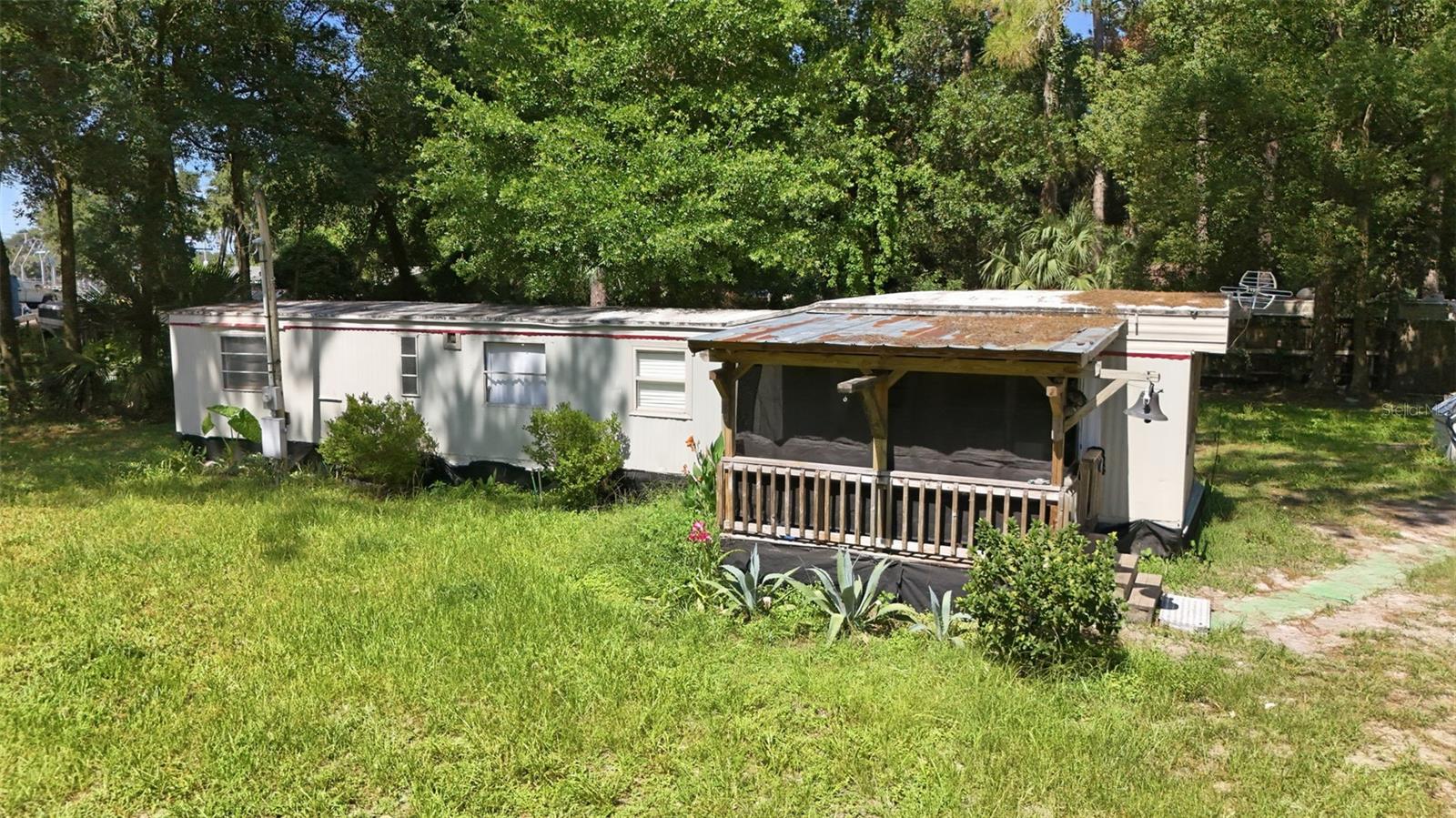 Discover this 1/3-acre vacant land parcel, offering an ideal opportunity for those planning to build. Located in a quiet country setting, the property provides a peaceful, natural environment while still being conveniently close to the Ocala National Forest, offering easy access to abundant outdoor recreation and wildlife. Just minutes away are a local library and public park, adding nearby community resources without sacrificing seclusion. The property also features an existing well and septic, adding valuable utility infrastructure. A mobile home currently exists on the property and is being sold as-is with little to no contributory value, presenting the option for removal as part of future plans. With its location, utilities, and flexibility, this parcel offers a great opportunity for a homesite in a serene setting.