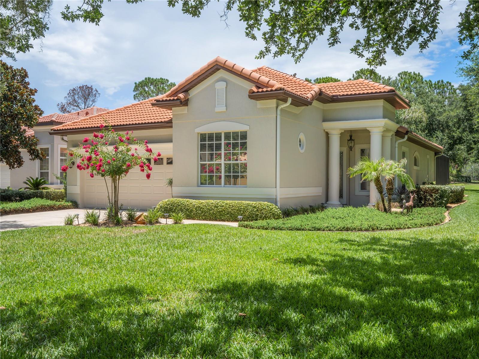 WELCOME TO THE MISSION RESORT’s GATED LAS COLINAS GOLF COMMUNITY!  If you are looking for a move-in-ready home, then you have found the perfect home. Charming 2B/2B/Den/2Car/Pool Spanish Mediterranean-style villa located on a lush, landscaped corner lot with large shade trees and views of the Las Colinas Golf Course 17th Fairway.  This beautifully designed 1691 SF feels much larger with an OPEN FLOOR PLAN that features 12’ ceilings in main living areas, 10’ ceilings in bedrooms, 8’ doors. LIVING ROOM: Entertainment center with gas fireplace. SPLIT BEDROOM PLAN for complete privacy.  French doors open from the breakfast nook, living room and primary bedroom to the lanai covered patio and pool. DEN: Can be an office or in this home it is the music room.  Add a closet and it can be a 3rd Bedroom. POOL: Enjoy the resort lifestyle in your own gas-heated 12’ X 24’ saltwater pool, which features an automatic sweeper.  The large lanai becomes your sanctuary during the daytime and at night you can relax with the stunning multi-shaded LED lights shining from the top of the lanai.  The warmth of this home begins with the entryway through the leaded glass front door and is enhanced by the lovely view of the pool.  KITCHEN: Galley kitchen, designed with granite countertops, updated (2021) Samsung appliances, gas stove, refrigerator, microwave, double sink & open bar to living room. Breakfast nook has lovely view of the pool through the French doors.  PRIMARY BEDROOM: Spacious 12 X 16 bedroom with sitting area, views of the pool/golf course and walk-in closets that feature built-in shelves. PRIMARY BATH: Double sink vanities & large shower. SECOND BEDROOM: Has private bath with large tub spa. LAUNDRY: Includes washer and gas dryer plus large storage space.  INTERIOR:  Easy maintenance begins with the (2021) high-definition multi-layered wood design laminate floor in living areas.  Tile floors in the foyer, kitchen and baths. (No Carpet). Plantation shutters throughout add the touch of elegance.  Some additional touches include: 3M tinted windows, Ceiling fans, Exterior painted (2025), Gas water heater (2021), 4 Zone sprinkler system controlled by App, Google – Nest thermostat controlled by App, Attic has pull-down access ladder with flooring & Gutters with leaf covers. MEMBERSHIP is REQUIRED. Select either a Social or Golf Membership. Live the RESORT LIFESTYLE at the MISSION (1100 acres) GOLF & TENNIS RESORT.  HOTEL, FOUR RESTAURANTS, GOLF, TENNIS, PICKLE BALL, BOATING, FISHING, sidewalks for WALKING throughout the community or just relaxing in the old-world charm.   This exclusive development is an unparalleled opportunity for the discerning buyer to live the lifestyle you have always dreamed of. Located in Central Florida, in the small town of Howey-in-the-Hills. Only 45 minutes north of Orlando, Disney, Universal, SeaWorld, & shopping malls. Arrange your private showing today!