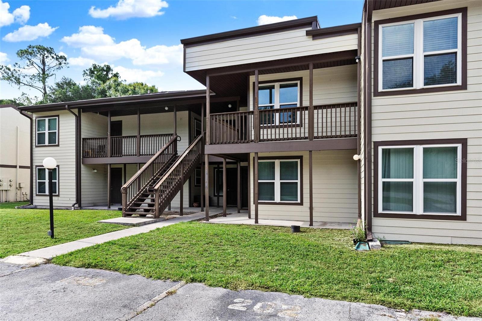 MAINTENANCE-FREE CONDO LIVING... Low-cost living and beautiful golf course views just minutes from The Villages, Brownwood, and Middleton shopping, dining, and schools! This remodeled and updated unit features newer cabinets and granite countertops throughout, along with a spacious great room showcasing vaulted wood beam ceilings and a cozy wood-burning fireplace. A bonus dining/flex space offers the perfect spot for entertaining or relaxing. The updated kitchen includes a brand-new range, dishwasher, side-by-side refrigerator, and washer and dryer that convey. With three spacious bedrooms and three full bathrooms, including private entrances for guest rooms, this home offers comfort and flexibility for family or visitors. Enjoy relaxing outdoors on the wraparound covered front deck, the perfect place to unwind and take in the surroundings. Community amenities include a pool, pickleball courts, and picnic/playground area for you to enjoy! The primary suite features generous triple closet space, creating the perfect private retreat.
