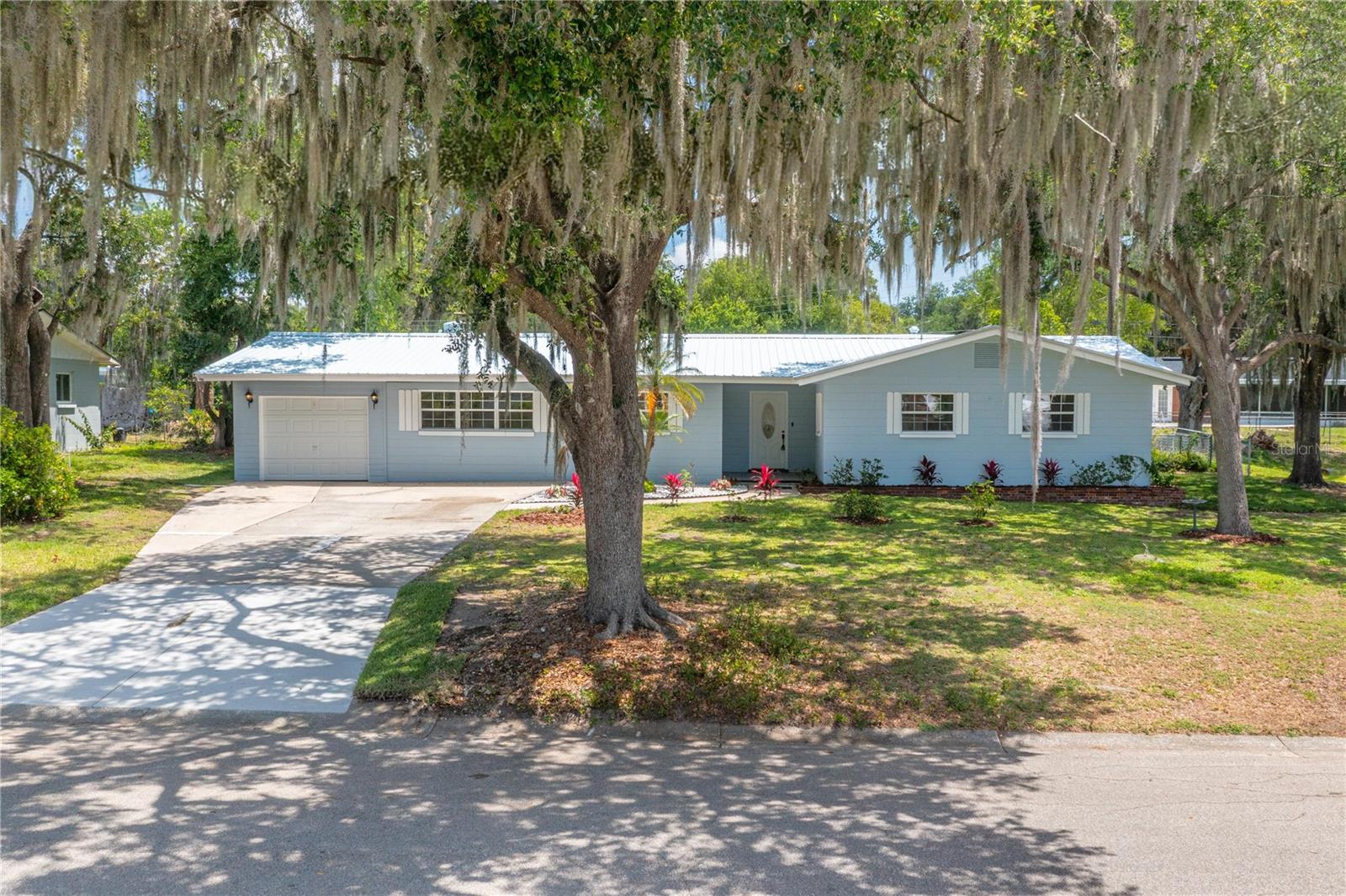 Beautifully RENOVATED FOUR BEDROOM, THREE BATH home with two of the bedrooms having private ensuite baths---- ideal for guests or multi-generational living! Beautiful kitchen with new cabinetry, countertops, stainless appliances including a wonderful 6 burner range. The kitchen is open to a large 12'x19' living room which seamlessly flows into a 13' x 29' family room with red brick fireplace. A versatile 14'x18' bonus room offers endless possibilities --- dining room, home office, or flex space to suit your lifestyle.  The spacious primary suite features a walk-in closet and bath with a deep jacuzzi tub and shower.  New CH&A, hot water heater, flooring, freshly painted interior/exterior. A convenient interior laundry room and attached garage with a convenient storage room. Plus metal roof and fenced backyard with utility shed for extra storage! This lovely move in ready spacious home is ideal for a family! A great home!