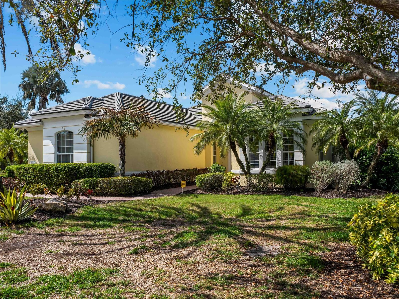 Experience "better than new" luxury in the gated University Park Country Club. Offered mostly furnished with a few exceptions. Situated on one of Kenwood Park's largest sites (over 1/3 acre), this home offers serene lake views and a side-load garage with a new roof (2023). Meticulously updated in 2022, every surface has be refined. The great room features a stone-accented electric fireplace and custom featured wall. A chef's kitchen boasts high-end appliances, an extended bar, and butler's pantry. The owner's suite includes a spa-bath with a TOTO washlet and frameless shower. A private den with built-ins easily serves as a 4th bedroom. Step outside to a expansive lanai featuring a panoramic screen, tile floor, and a fresh Sunbrella electric awning-all complemented by a convenient half bath. Additional upgrades: new HVAC (2023), whole-house water softener, and generator. Kenwood Park residents benefit from an exclusive community pool shared by only 77 homeowners- the perfect hub for quaint social gatherings. Ideally located just minutes from the UTC shopping and dining district, downtown Sarasota, and world class beaches. Residents enjoy 27 holes of championship golf, 11 lighted Har-Tru tennis courts, and state-of-the-are fitness center in a premier social environment.
