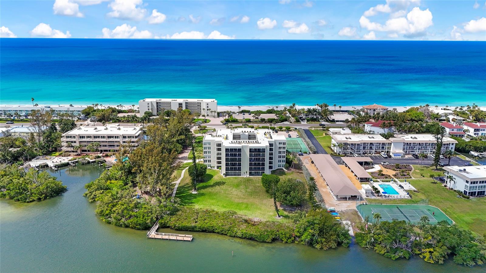 Experience tranquil island living in this beautifully maintained first-floor residence at Portobello, offering private, serene views of expansive grounds, lush mangroves, and the bay. With your beach, shimmering Gulf waters, and breathtaking sunsets just across the street, this is the perfect coastal retreat.

Designed with a desirable split floor plan, the home is filled with natural light from sliding glass doors that span the width of the residence. The large screened-in lanai is accessible from the living area and both bedrooms—seamlessly blending indoor and outdoor living while overlooking a generous grassy yard space and peaceful bayou, perfect for canoeing and kayaking right from your backyard.

The kitchen features granite countertops and stainless steel appliances. Offered turn-key and fully furnished, this residence is move-in ready and ideal for seasonal or full-time living.

Portobello is a sought-after Beach-to-Bay community ideally located mid-Key, offering an exceptional array of amenities including 600 feet of private beach frontage and 260 feet along the bay. Residents enjoy a heated community pool, tennis courts, clubhouse, BBQ and picnic areas, fishing pier, and kayak launch. 

Just minutes from the world-class shopping and dining of St. Armands Circle and everything Sarasota has to offer, this exceptional residence invites you to experience the pinnacle of Longboat Key living—where every day feels like a vacation.