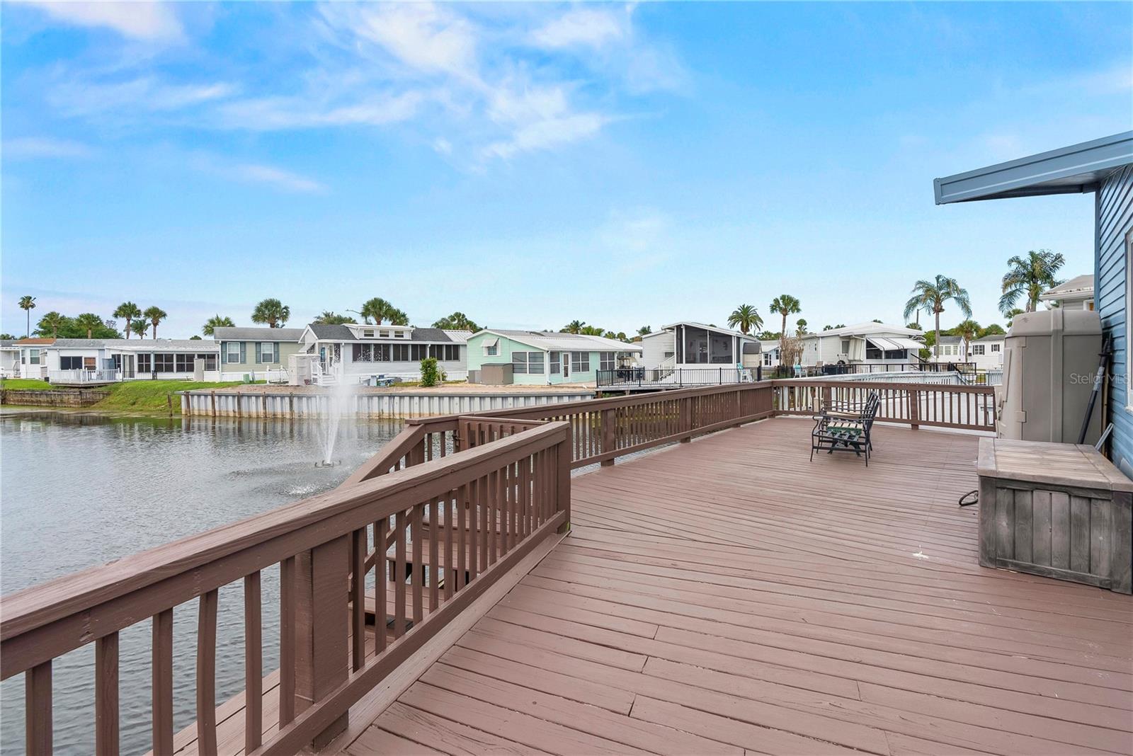 Beautifully updated waterfront home located in the highly sought-after gated community of Outdoor Resorts at Orlando, perfectly positioned on a canal with direct access to Lake Davenport. This move-in ready property offers an exceptional combination of modern upgrades, outdoor living, and a true Florida lifestyle.  Step outside and enjoy the expansive rear deck and private dock, where you can relax and take in tranquil water views, complete with an uninterrupted view of the fountain. A side patio provides additional outdoor space and convenient access to the rear of the home—ideal for entertaining or simply unwinding in your own private setting.  Inside, the home has been thoughtfully updated throughout. The kitchen has been recently replaced and enhanced with butcher block countertops, slide-out shelving, and newer appliances, including a propane gas stove—perfect for those who love to cook. Luxury vinyl plank flooring installed in 2024 runs throughout the home, offering a clean, modern look and easy maintenance.  Major upgrades provide peace of mind, including double-pane windows and sliding doors installed in 2025, a newer tankless water heater, a new internal electrical panel, and a durable metal roof.  The layout is both functional and comfortable, with a Florida that includes a dedicated area with full-size washer and dryer.  The bathroom features a tub with shower, and the bedroom overlooks the water and includes built-in closets, drawers, and a queen-size bed with additional storage.  Outdoor Resorts at Orlando is a gated lakefront community offering resort-style amenities including 2 pool, club house, golf, tennis, pickleball and community boat ramp with access to Lake Davenport.  Whether you're looking for a full-time residence, vacation getaway or investment property, this beautiful upgraded waterfront home is a standout opportunity to enjoy the very best of Florida living within minutes of Walt Disney World.