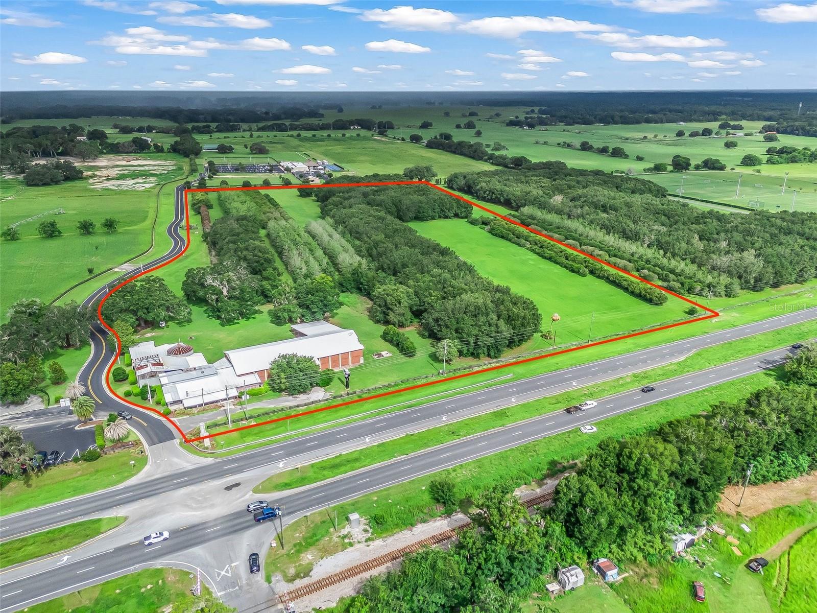 DYNAMITE LOCATION! Prime 21.7+/- Acre Industrial Property for Sale in Summerfield, Florida. This strategically located industrial property in the heart of northern Central Florida with an approved Planned Unit Development (PUD) zoning for a wide variety of uses. Situated between key commercial hubs such as I-75, the Florida Turnpike, The Villages, Lady Lake, and Ocala, this property is ideally positioned for manufacturing, warehousing, distribution, contractor yards, and other industrial uses. The proximity to major transportation routes ensures easy access for logistics and operations, with the Florida Turnpike, I-75, and Highway 44 interchange only 15 minutes away. Approved Zoning for Diverse Uses. The zoning allows for: Manufacturing facilities, Warehousing and distribution, Contractor yards, (retail/wholesale), Plant nurseries, Processing of products produced on-site, Cardroom facilities, Storage of building supplies, equipment, and materials, Open storage areas, Fuel storage, Auto wrecking/junk yards, This flexible zoning makes the property ideal for a range of industries and businesses, and offers the unique advantage of bypassing the often lengthy and costly zoning process that many other properties face. Extensive Development Potential. The property allows for up to 400,000 square feet of gross development, providing ample space to build out facilities for manufacturing, warehousing, or distribution. Whether you are looking to expand an existing business, set up a new operation, or build a large industrial complex, this site offers the space and approved zoning to bring your vision to life. On-Site Infrastructure, Existing Buildings: The property includes a 9,000+/- square foot industrial building previously used for agricultural supplies and storage. This building features air-conditioned office spaces, and can serve as immediate office or operational space as you develop the property. Utilities: Essential utilities such as water and sewer are provided by Marion County Utilities, which is already connected to the site along US Highway 301.  Outstanding Location & Accessibility. Located in an area that is experiencing continuous growth, this property is perfectly positioned to benefit from the ongoing development of Central Florida. The surrounding area offers convenient access to both local and regional markets, with major highways and infrastructure supporting both local and interstate commerce. 15 minutes to the Florida Turnpike, I-75, and Highway 44 interchange. 
Close proximity to The Villages, Lady Lake, and Ocala, providing a large labor pool and nearby services. A Rare Opportunity! Heavy commercial and industrial land is becoming increasingly difficult to find in Florida, and properties with this level of zoning approval are even more rare. This is a unique opportunity to secure a site with the infrastructure, location, and approved zoning necessary to support a wide variety of commercial and industrial operations. This property offers tremendous value for businesses looking to expand, invest, or relocate to a prime industrial location in northern Central Florida. With the zoning already in place and a range of approved uses, this site is ready to accommodate your business needs today. Copy this link for the VIDEO: https://opulent-rem.aryeo.com/videos/0197d5de-a7ca-71b1-9d40-eff717ec0109