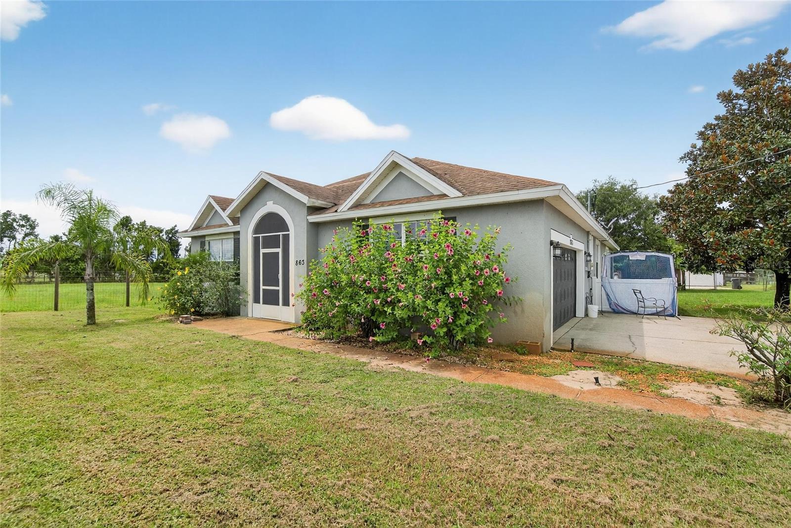 RARE FIND – TWO SINGLE-FAMILY HOMES ON OVER AN ACRE! This unique property in Lake Wales offers the perfect setup for a large multi-generational family, in-law suite, or an excellent income-producing rental opportunity. The fully fenced lot is dotted with fruit trees and provides privacy and space to enjoy. (Home in front (4/2) is now going completely repainted and carpets cleaned)

The main home features 4 bedrooms, 2 bathrooms, and 2,170 sq. ft. of updated living space, including fresh interior paint, new flooring in the main living areas, a spacious eat-in kitchen, and a large great room with combined dining and living areas. Step out to the screened back patio and take in the peaceful yard.

The guest home, built in 2016, offers 3 bedrooms, 2 bathrooms, and 1,300 sq. ft. of heated living space. Highlights include an updated kitchen and baths, a large open kitchen-to-living layout, inside utility, 2-car garage, and screened patio. This second home also has its own private driveway and fencing, making it ideal as a rental or in-law residence.

Don’t miss this rare opportunity—two move-in ready homes on one beautiful property with endless possibilities!