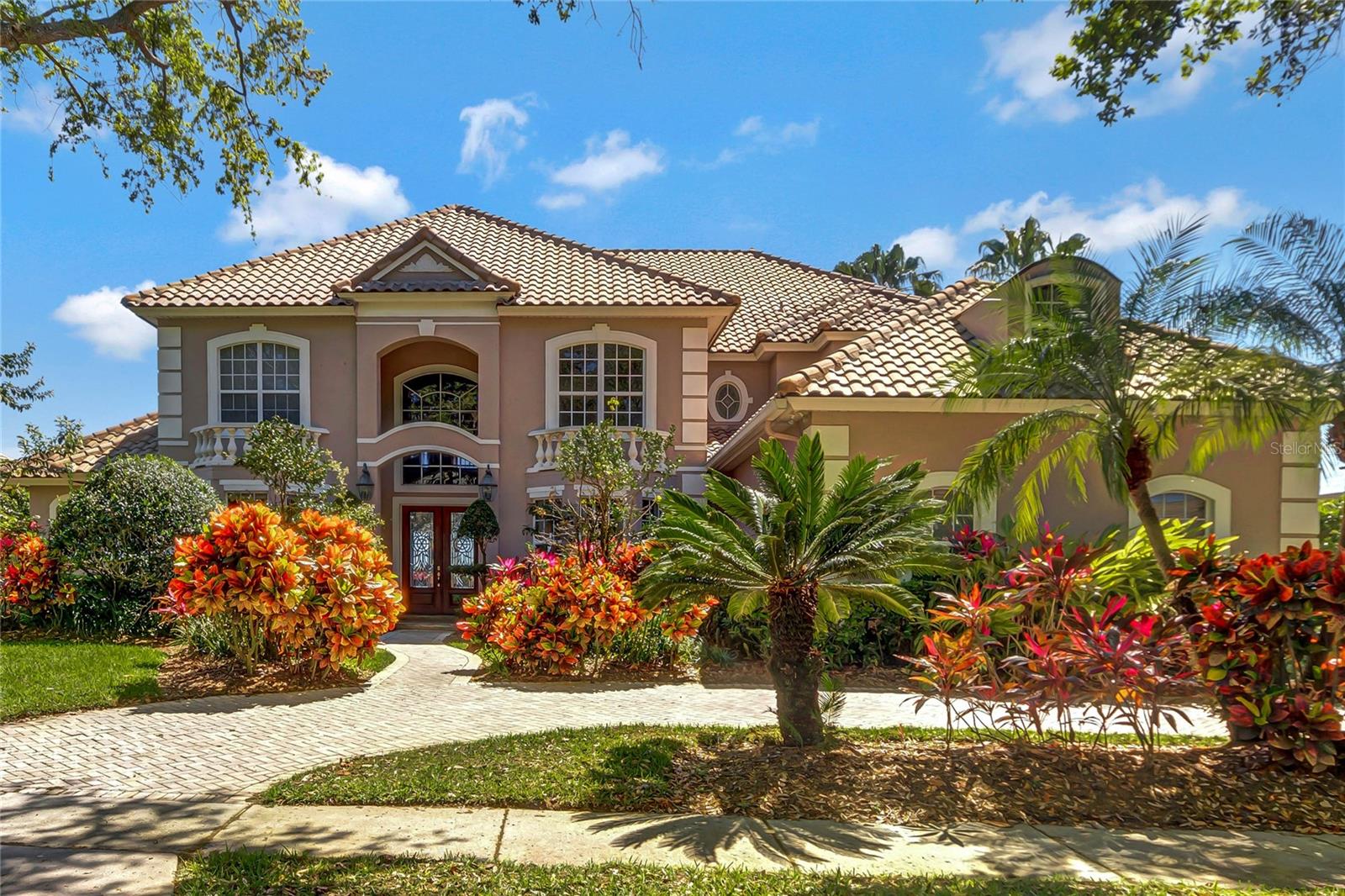 STUNNING LAKEFRONT HOME WITH AMAZING INFINITY EDGE POOL. GRAND ENTRY WITH VIEW OF POOL & LAKE. Must see this 23 ft. Ceiling with decorative design in living and dining area. 5 beautiful Bedrooms plus LARGE ENTERTAINMENT ROOM / THEATER ROOM. WITH WET BAR 30 X16 Master with His & Her Closet plus Jacuzzi and Study downstairs with built in cabinets with private bathroom. 5th Bedroom can be Home Office. EXTRA LARGE FAMILY ROOM WITH SPECTACULAR LAKE VIEWS + GAME ROOM.  Double crown molding, columns, and open floor plan. Wide upstairs hallway. Fantastic view with bedrooms either side, and lots of space. Open Kitchen with Granite Island, extra-large Pantry, and all stainless-steel appliances included. Master + Study Down, 4 Bedroom + Bonus Room Upstairs. 3 A/C’s newly replaced.  LARGE LOT with Mature trees and lush landscaping. Exterior Painting done in 2022 LARGE POOL & SPA, HUGE PORCH INCLUDES BUILT IN SUMMER KITCHEN WITH SINK. 3 Car Side Entry Garage, Circular Drive, Termite Bond, 24 hour gated and guarded community, 3 playground areas, Tennis Court, Basketball Court, and Community Boat Dock. Close to hospitals, schools, doctors’ offices, 80+ restaurants, Trader Joes & Whole Foods. 25 minutes to the International Airport, & Disney World. 5-10 minutes to malls, many grocery stores & fitness centers. Best of everything in Dr. Phillips area. Enjoy Phillips Landing! (Sq. Ft. per Builder Plan) CANNOT FIND A BIG HOME AT THIS PRICE IN A 24 HOUR GUARDED AND GATED COMMUNITY IN DR. PHILLIPS. HURRY AND SEE THIS BEAUTY.