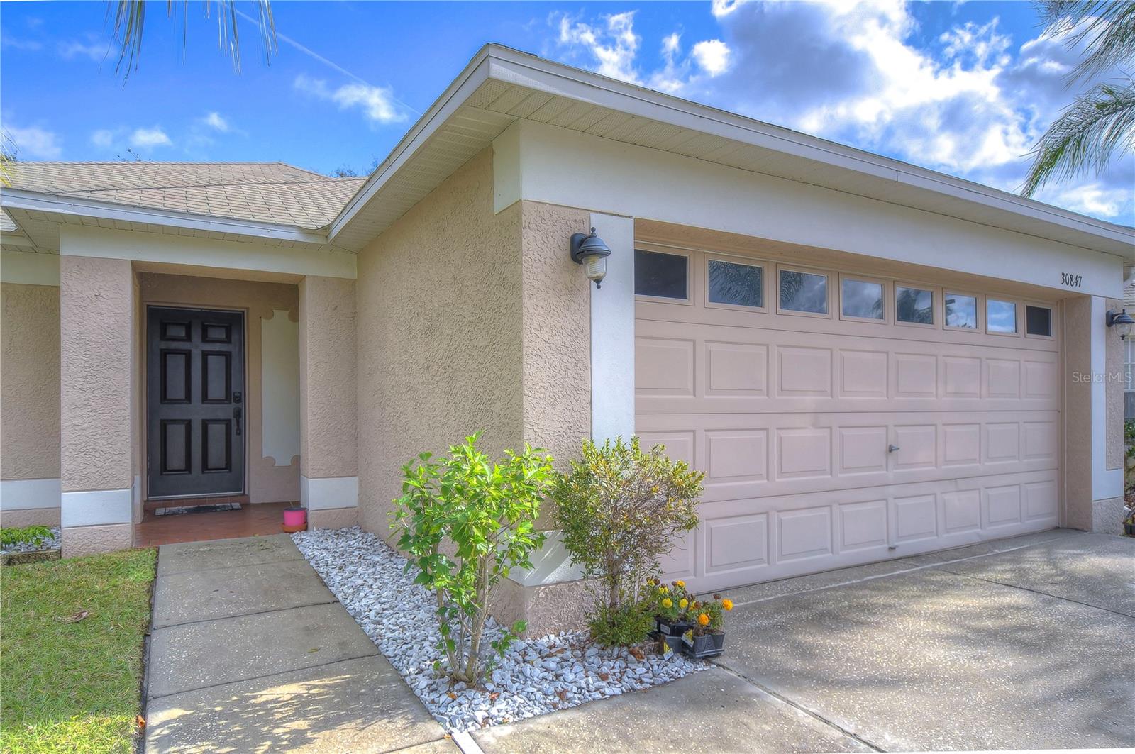 Gorgeous View! Come home to wide open pond view 4-bedroom 2 bath home in Bridgewater of Wesley Chapel. 2 miles from EPPERSON LAGOON. As you enter you are welcomed to a light and bright living room and dining room with wood laminate flooring and high ceilings. The kitchen has granite countertops and has and large French door refrigerator. This floor plan packs a punch with 4 bedrooms making this home feel larger than it is. The rear of the home has a covered lanai with that spectacular view onto the serene water. LAWN CARE Included and Washer and Dryer Included. Bridgewater has a community Park, soccer field, basketball court, playground, dog park, and walking trails. It’s conveniently located minutes from I-75, Wiregrass Mall, Tampa Premium Outlets, the Groves, and myriad of restaurants and plenty of shopping.