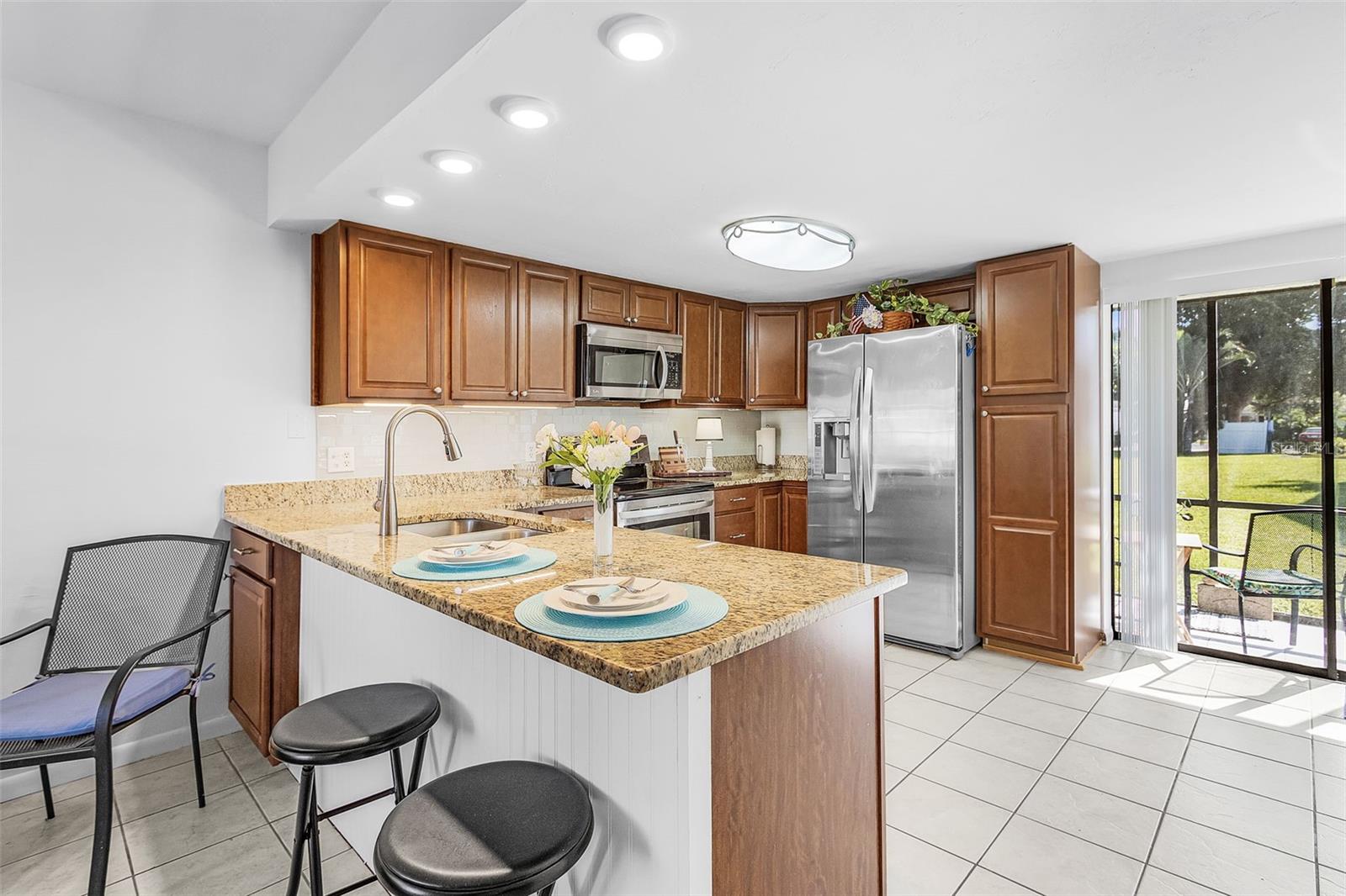 Don't miss this incredible opportunity to own a beautiful 2-bedroom, 2.5-bathroom townhome in the heart of downtown Cape Coral. This ideally located end-unit townhome boasts an extra window for added natural light and is perfectly situated right next to the crystal-clear, heated pool—ideal for year-round enjoyment. The pool area is thoughtfully designed with a shaded section featuring picnic tables, benches, and a community grill for your convenience and leisure. Nestled in a quiet, peaceful community, this home offers the perfect balance of tranquility and accessibility, with shopping, dining, and an array of amenities just around the corner. Plus, you're only 20 minutes from Fort Myers Beach and 25 minutes from the stunning Sanibel Island. Step inside to find tile and vinyl flooring throughout the main living areas, creating a sleek and modern atmosphere. The spacious kitchen is a chef’s dream, featuring beautiful granite countertops, wood cabinetry, and stainless steel appliances. Both bedrooms come equipped with two closets each—perfect for storage—while the primary suite enjoys the luxury of two walk-in closets. The secondary bedroom offers a built-in closet along with a walk-in closet, maximizing space and organization. The primary bath features a sleek vanity and a walk-in tile shower, while the secondary bath includes a vanity and a shower/tub combo with stylish tile walls. A convenient half bath downstairs adds to the appeal of this thoughtfully designed home. Additional features include a valuable Pilot brand built-in stair lift, which can be kept or sold at the buyer's discretion. Start your day with a beautiful sunrise from your screened-in lanai, and enjoy the quiet, scenic surroundings. This is an exceptional chance to secure a stunning condo in an unbeatable location—schedule your showing today!