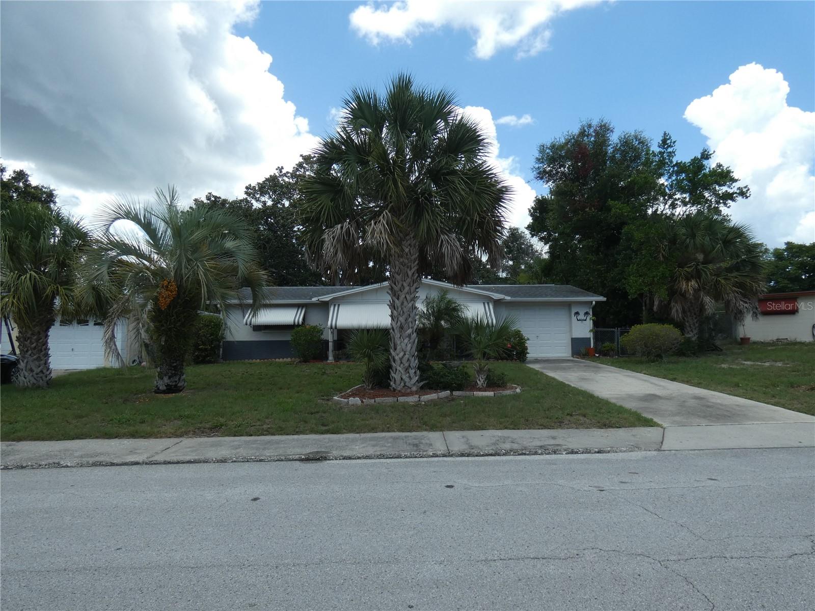 Great location , close to Gulf High school, and Downtown New Port Richey and all the fun entertainment that it has to offer such as the library, restaurants, art gallery, the theatre and some great events such as the Chasco Fiesta and the Street and boat Parades. Close to Tarpon Springs Sponge docks and esy commute to Clearwater Beach and The Tampa Airport via the Suncoast Pkwy. This 2 bedroom, 1.5 bath, Large family room, front porch and Back porch and 1 car oversized garage home is fully fenced and has been well maintained. Front of house newer paint and some newer interior doors., great curb appeal. Needs a little updating and carpeting because it is dated but will be great starter home, 2nd home or Vacation home. Close to Gulf High school, and Downtown New Port Richey and all the fun entertainment that it has to offer such as the library, restaurants, art gallery, the theatre and some great events such as the Chasco Fiesta and the Street Parade. Close to Tarpon Springs Sponge docks and esy commute to clearwater Beach.