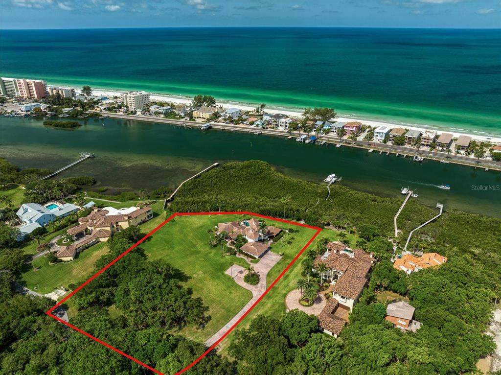 Under contract-accepting backup offers. Rare! Estate property with two expansive acres on the intracoastal waterway!  This 4 bedroom, 4.5 bath pool home is situated along the waterfront. Once you drive up the tree-lined, private road to this property you are greeted with a beautiful fountain and koi pond.  The first floor features a kitchen with wood cabinetry with custom glass inserts, stone countertops and stainless steel appliances. The kitchen features an island and a cozy breakfast nook   The living room features a vaulted wooden ceiling with access to a covered porch that overlooks this gorgeous property. This level  also includes a dining room, formal living area and 3 more bedrooms each with en-suite baths. The second floor boasts a large primary bedroom with a generous bath and separate tub and shower. This level has a private balcony overlooking the pool and the beautiful westerly views.  The composite dock includes power and water with a lift and a wet slip. Bring your boats, paddle boards, jet skis, kayaks and fishing rods! The 3 car garage includes an air conditioned workroom. Golf cart to the beach and fine dining including waterfront restaurants!  This unique property has R-R Zoning, therefore, horses and other farm animals are permitted.  There are so many possibilities here--must see to appreciate all the offerings of this estate!