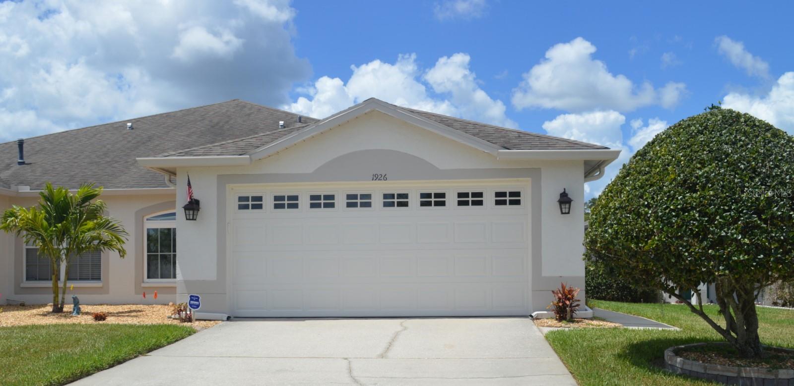Picture-perfect villa on a serene pond/conservation homesite in the desirable gated Longleaf village of Meadow Pointe. This beautifully maintained home features 2 bedrooms plus a den with double doors ideal for an office, study, or optional 3rd bedroom. The upgraded floor plan includes a bright 7x12 sunroom, a screened lanai overlooking the tranquil pond, and 2 full baths. The well-planned kitchen offers ample storage and workspace countertop space that comes fully equipped has an adjacent breakfast area filled with natural light. Flooring has been elevated with premium porcelain tile in the kitchen, primary bedroom, and both bathrooms, complemented by the engineered wood flooring in the great room, study, and second bedroom. The primary suite includes a garden tub, separate shower, and dual vanity. All appliances convey, including the front-loading washer and dryer. The home also includes double pane windows and garage door with battery backup. This villa delivers exceptional value with low HOA fees that cover exterior painting (completed in 2025), lawn care, limited roof repair, roof replacement, and reserves for both roof and painting. The village also benefits from reclaimed water for irrigation, keeping landscaping lush and cost-efficient. Residents of Meadow Pointe II enjoy outstanding amenities: a clubhouse, fitness center, community pool, tennis courts, basketball courts, and playground—all just minutes away. Located in the heart of Wesley Chapel, this home is close to top-rated schools, shopping, restaurants, hospitals, the University of South Florida, Pasco Hernando State College, parks, walking and biking trails, and offers easy access to major interstates.