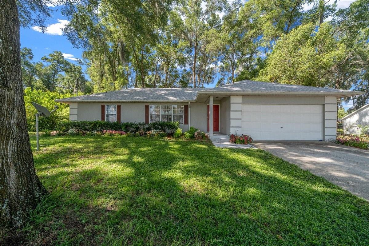 Enjoy the comfort and convenience of this well-maintained 3-bedroom, 2-bath home featuring 1,352 living square feet, a desirable split floor plan, and a 2-car garage. Architectural details include vaulted ceilings and attractive chamfered arch doorways, while a large front window fills the home with natural light.
The kitchen offers abundant cabinet space, includes all appliances, and flows seamlessly into the dining area, creating an inviting kitchen/dining room combination. Sliding glass doors from the dining area open to a screened Florida room, providing the perfect space to relax and enjoy the outdoors. The primary suite features a vanity area, multiple storage drawers, and a convenient linen closet.
Situated on an oversized, high-and-dry 0.33-acre shaded lot, this property offers plenty of elbow room along with attractive landscaping, a double-door storage shed, and an expanded driveway with extra parking for guests.  Exterior features include a new roof in 2025,  a quality Trane HVAC system as well as a gutter system. Some furnishings are negotiable. Located just outside the city limits, you'll enjoy the freedom of no HOA while remaining close to shopping, schools, and everyday conveniences. This move-in-ready home offers a wonderful combination of space, functionality, and value.