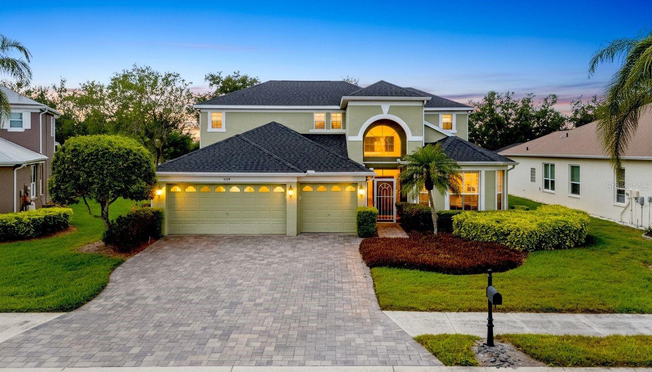 Elegant curb appeal awaits in this four-bedroom, three-and-a-half-bathroom Estates at Glenn Lakes infinity pool and golf course residence. Your backyard oasis and beyond along the Manatee County Public course 9th fairway. There is a buffer pond between the property line and links providing optimum privacy.  A daily event of panoramic western sunset views visible from nearly every room in the home.  The paver driveway and entry lead through the double-doors to interior soaring ceilings opening to the second-floor balcony. From there, it’s a smooth transition to formal dining and sitting areas simply the perfect spot for hosting guests. You will be drawn to the backdrop of the pool and exterior space as you walk through a threshold to an open kitchen/great room. Beautiful granite countertops, 42" cabinetry, a sunny breakfast nook dinette, blending high-end style with everyday functionality. The main-floor primary suite offers a private sanctuary with an abundant amount of natural light to exterior serenity and beyond. The suite features dual walk-in closets that lead to a luxurious Roman tub, a separate walk-in shower, and dual vanities. Step out to your outdoor oasis lanai to enjoy a stunning, salt-chlorinated, heated infinity pool. Surrounded by ample deck space for entertaining and convenient to the dedicated half-bathroom located just off the lanai. The second level opens to a versatile seating area at the top of the staircase. There are three full bedrooms: two share a well-appointed full bathroom, while the third serves as a private guest suite with its own en-suite full bath. You will have total peace of mind with an air conditioning unit dedicated to each level of the home. They were replaced in 2025 and 2026. A completely new roof was put on in 2021. Spacious three-car garage is a premium upgrade for all the toys and ample storage possibilities. The Estates at Glenn Lakes is a deed-restricted maintenance-free single family home lifestyle. A monthly HOA fee of $209.00 covers weekly lawn care, exterior irrigation, and system upkeep, allowing you to spend your time enjoying nearby amenities. This prime location places you just minutes from multiple dining and shopping options, the world-renowned IMG Academy,  and the beaches of Anna Maria Island.