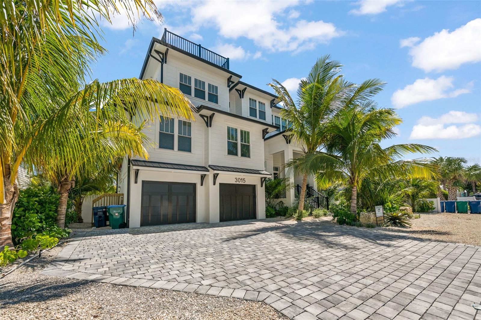 Discover this exquisite 4-bedroom, 4.5-bathroom luxury beach house, completed in 2023, located just one block from the pristine sands and turquoise waters of Bradenton Beach on Anna Maria Island. This custom-built residence is a true masterpiece of modern design and exceptional craftsmanship, offering a lifestyle that blends elegance, comfort, and coastal charm in one of Florida’s most coveted locations. Every detail of this home has been meticulously crafted, with no expense spared. The gourmet kitchen features custom solid wood cabinetry, high-end built-in appliances, and stunning quartz countertops, setting the stage for both culinary creativity and entertaining. Vaulted ceilings with custom trim work enhance the home’s airy, open feel, while designer light fixtures, furnishings, and decor exude sophistication throughout. With hurricane impact windows and doors, this home provides not only style but also security and durability. The sprawling master suite is a true sanctuary, complete with an oversized walk-in closet and a spa-inspired ensuite bathroom, offering the perfect retreat after a long day. This home is designed for both relaxation and entertaining, with multiple living spaces that flow seamlessly from one to another. Step outside to the private backyard oasis, where you’ll find a sparkling pool and spa surrounded by lush tropical landscaping, offering the ultimate setting for enjoying the Florida sunshine. For those seeking fun and relaxation, the game room and putting green provide endless entertainment options. The crowning jewel of this extraordinary home is the rooftop deck, which boasts panoramic views of the Gulf of Mexico. Whether you’re enjoying a breathtaking sunset, hosting an evening gathering, or simply taking in the serene surroundings, this space is truly one-of-a-kind. With the beach just a short stroll away, you’ll have endless opportunities for sunbathing, swimming, and beachcombing at your doorstep. This luxury beach house is more than just a home; it’s a lifestyle. Whether you seek peace and tranquility, an active coastal adventure, or the perfect space to entertain loved ones, this property delivers on every level. Seize the opportunity to own a piece of paradise. Indulge in the ultimate in luxury living with exceptional design, unparalleled views, and an unbeatable location. This is the home you've been dreaming of.