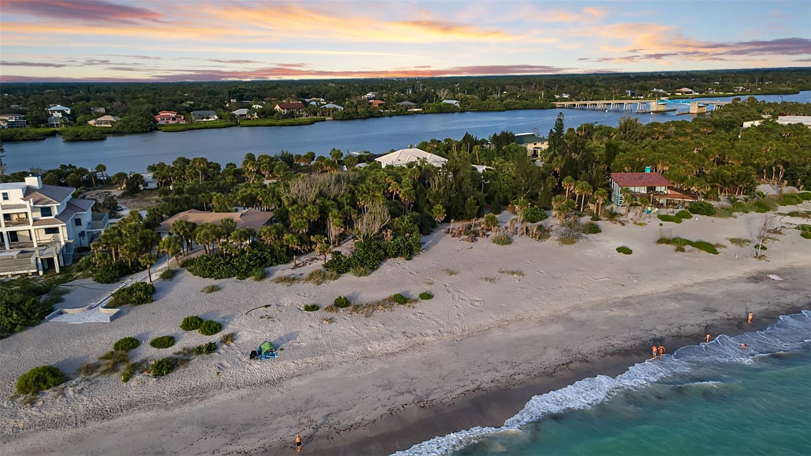 This is the rare blank canvas—a true Gulf-to-Bay homesite within the gated, private enclave of Manasota Key, where you design the dream rather than inherit someone else's. Spanning 1.17 acres across two parcels, the property holds 103 feet of sugar-sand Gulf beachfront and 94 feet of frontage on Lemon Bay: 197 feet of water in all, and a setting most owners spend a lifetime searching for.

Imagine the home you would build here. Walls of glass framing the Gulf, primary suite oriented to the sunrise over the bay, a pool sited between the water and the palms, and room for every detail that makes a house unmistakably yours. With water on both sides, the architecture writes itself.

Then picture the life: morning coffee on the sand as dolphins roll past, the boat launched from your own bay frontage, the sky turning gold over the Gulf each evening. Behind the gates, life slows—white-sand beaches and the calm, fishable Intracoastal moments from your door, Englewood's shops and dining an easy drive away.

Homesites of this scale and dual-water frontage rarely come to market here. Bring your architect, and build the legacy retreat you've always imagined on one of Florida's last truly private barrier islands.