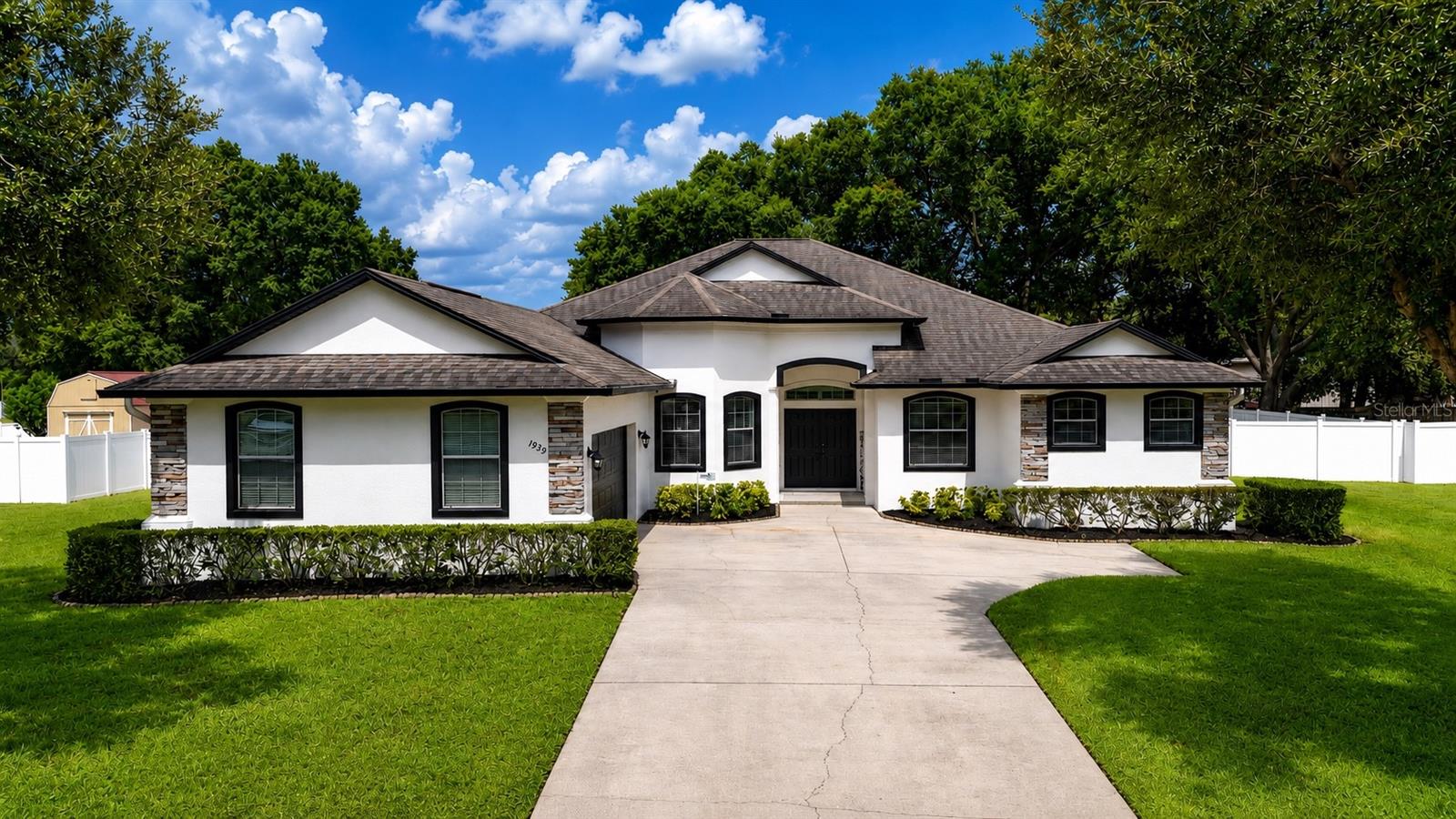 Looking for a move-in-ready home with a pool, nearly half an acre, a private guest suite, and incredible space for entertaining inside and out? This may be the one!
Beautifully maintained and reflecting pride of ownership throughout, 1939 Griffin Trail is an impressive Southern Homes Lexington model located in a desirable gated community with low HOA fees and no CDD.
Even the arrival makes an impression. The home’s unique L-shaped design and garage placement create a spacious front courtyard, an oversized garage, and a long driveway with plenty of parking. Step through the elegant double doors and you are immediately greeted by soaring 12-foot ceilings and a true wow factor.

The heart of the home is the spacious chef’s kitchen, featuring a gas range and seemingly endless countertop space. It opens to a huge family gathering room and dining nook, creating a warm and inviting setting for cooking, entertaining, and everyday living.

The thoughtfully designed triple-split floor plan offers 4 bedrooms, 3 bathrooms, a private office, an oversized laundry room, and a dining area that can also serve as a den or flex space. One side of the home features a bedroom with its own en-suite bathroom, creating a private and comfortable retreat for guests or extended stays. The massive primary suite provides plenty of room to unwind, along with a spacious private bathroom.
Just when you think you’ve seen it all, step outside into your own Florida retreat! The expansive outdoor space features a large swimming pool, a covered cookout and entertaining area, and a spacious fully fenced backyard. There is plenty of room for summer barbecues, pool parties, outdoor activities, or simply relaxing in the Florida sunshine.
Conveniently located near shopping, restaurants, and major highways, this home offers easy access to both Orlando and Tampa. Come experience everything this beautiful property has to offer—schedule your private showing before it’s too late!