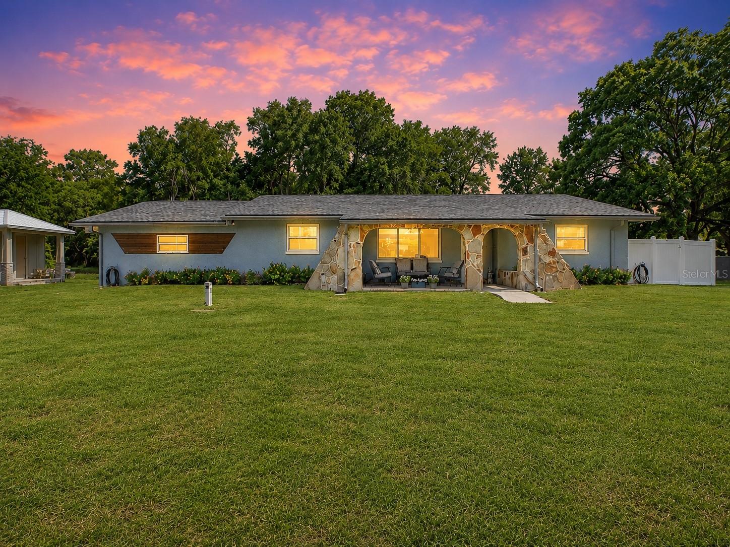 One or more photo(s) has been virtually staged. Welcome to this stunning coastal farmhouse nestled in the heart of Odessa’s desirable Keystone area. A meticulously maintained block construction pool home set on a generous 0.29-acre lot with no HOA and no flood concerns. This is the kind of neighborhood where neighbors keep horses, and there’s plenty of space for your lifestyle, including room for a large RV or boat. The fully-enclosed backyard was made for Florida living. An expansive paver patio wraps around the refreshing pool with plenty of room to make it your own — think outdoor kitchen and cozy fire-pit for enjoyable outdoor evenings. A separate enclosed area is perfect for pets or a future chicken coop, and the yard also features a raised garden bed and a new 12x12 shed, all while still leaving open space for play, entertaining, or simply soaking up the Florida sunshine. Whether you’re into backyard chickens, a garden, or just want room to breathe, this property delivers. Inside, a bright open-concept layout welcomes you with porcelain tile flooring throughout the main living areas and a cozy fireplace perfect for those rare chilly evenings. French doors with built-in blinds open directly to the pool and patio, making indoor-outdoor living effortless. The kitchen is where this home truly shines, with quartz countertops, soft-close solid wood cabinetry, stainless steel appliances, a fireclay farmhouse sink, and a shiplap island that feels right at home in this neck of the woods. Barn doors on the walk-in pantry and guest bath add that signature coastal farmhouse character that fits the spirit of the Keystone area perfectly. The split-bedroom layout offers privacy for owners and guests alike, and the primary suite includes a spacious 7x13 wardrobe retreat ideal for the organization enthusiast. All appliances, including washer and dryer, convey with the home. Major updates provide peace of mind, including a new roof and fresh interior and exterior paint completed in 2022, making this home truly turnkey and move-in ready. Odessa’s Keystone area is one of Tampa Bay’s best-kept secrets! Top-rated schools, nearby parks, shopping, and dining, all wrapped in a relaxed, rural-meets-refined lifestyle that’s increasingly hard to find. Spacious lots, private pool, no HOA, and a community where the equestrian life is just down the road. If you’ve been searching for an escape from the ordinary — this is it.